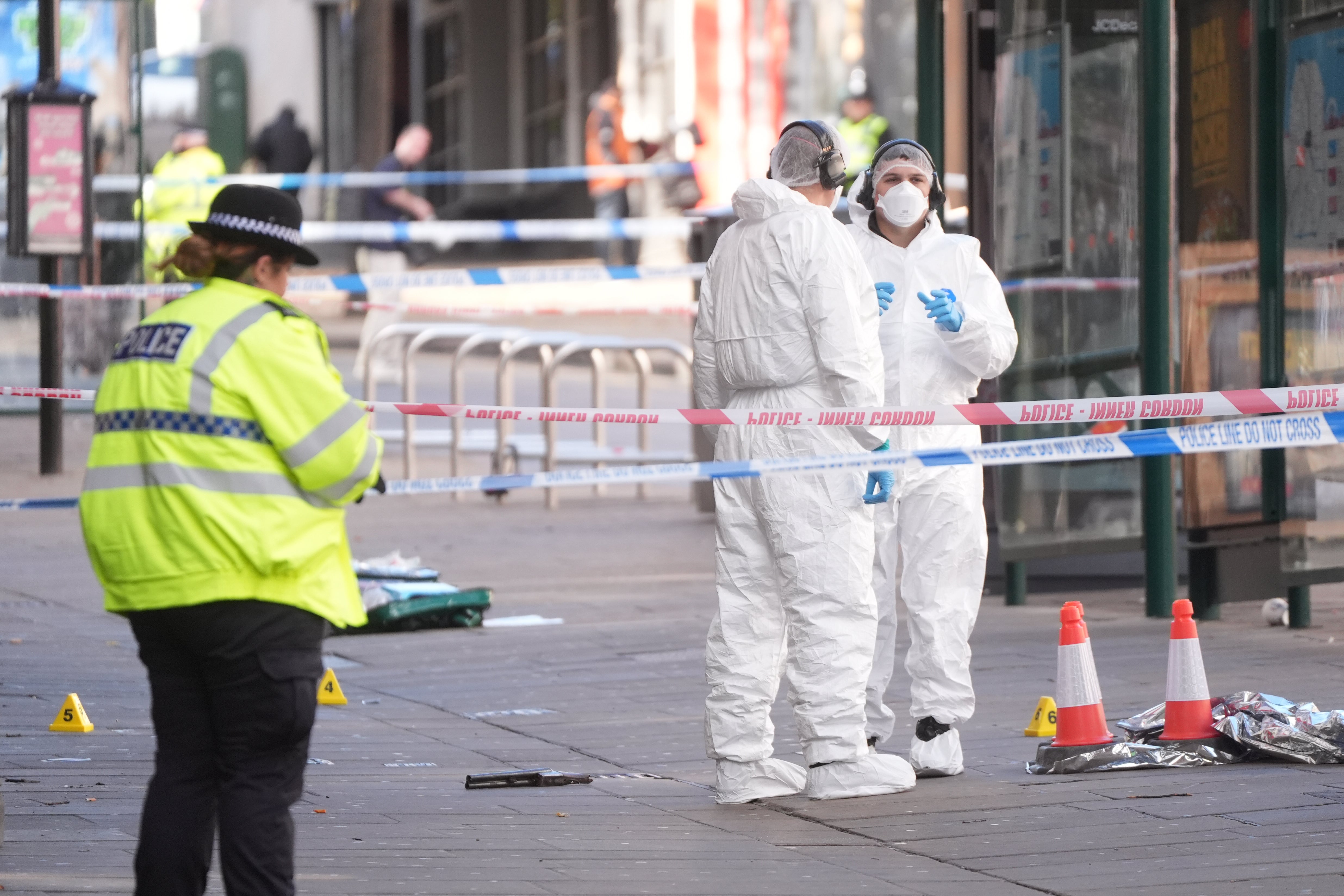The officer, who is in hospital with a foot wound, had approached two suspects in Angel Row shortly before the incident at 4.50am on Sunday, Nottinghamshire Police said