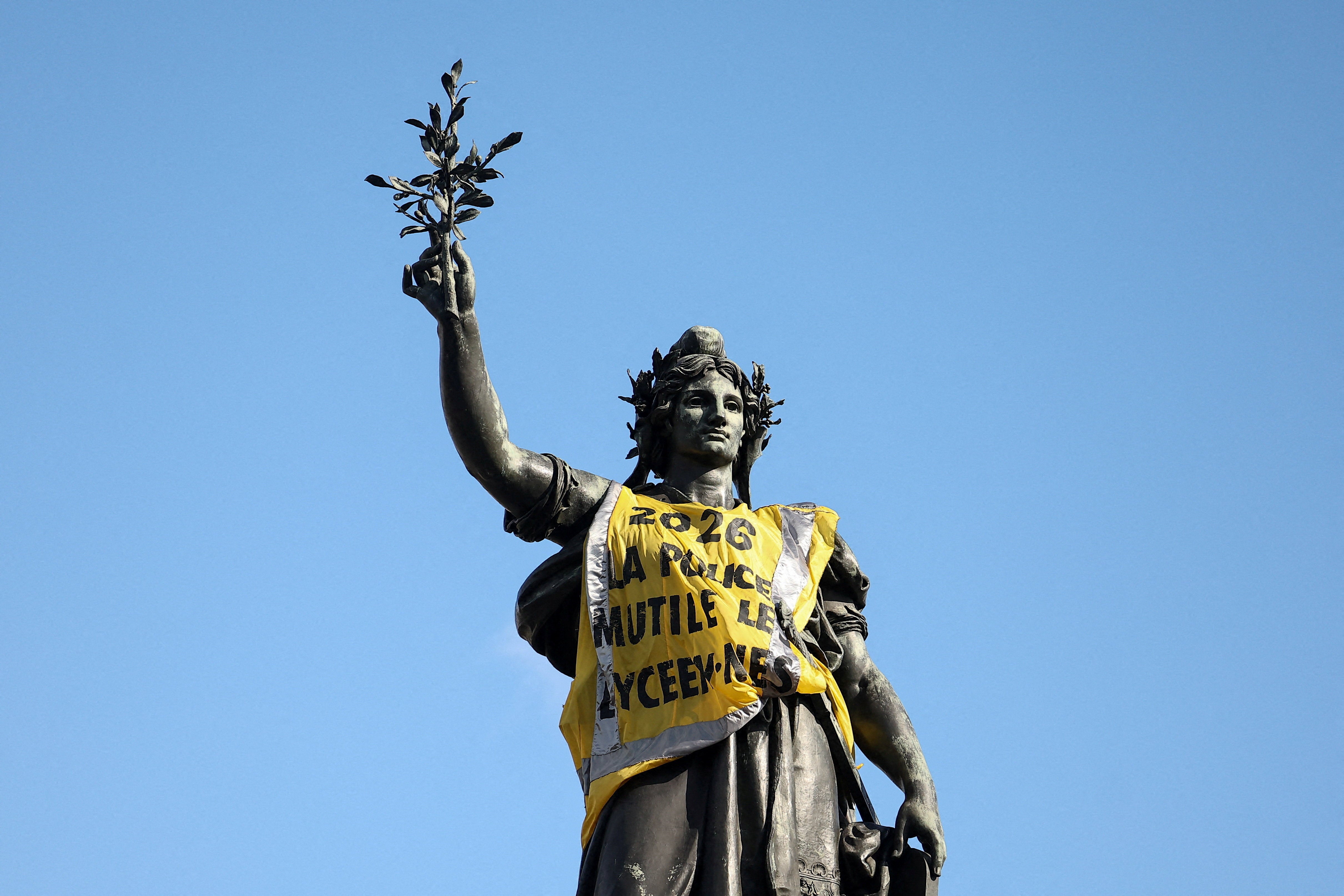 The Monument a la Republique, representing Marianne, with a yellow vest, the day after clashes during a national day of demonstrations