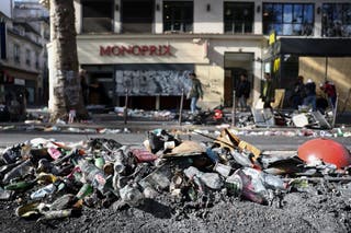 Ashes and rubbish on the side of a street, the day after clashes during a national day of demonstrations