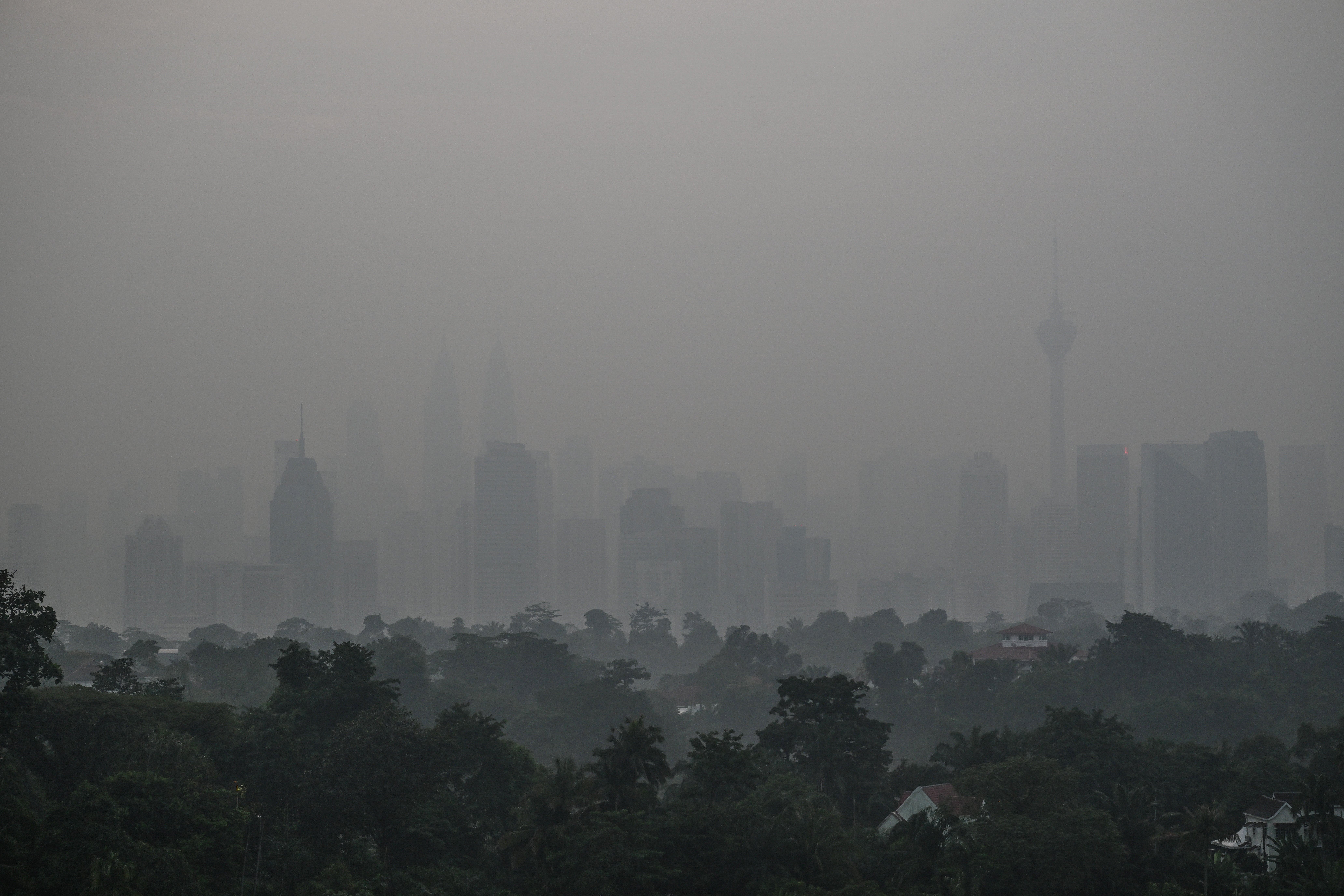 The skyline of Kuala Lumpur is seen amid thick smog during sunrise on 17 October 2026