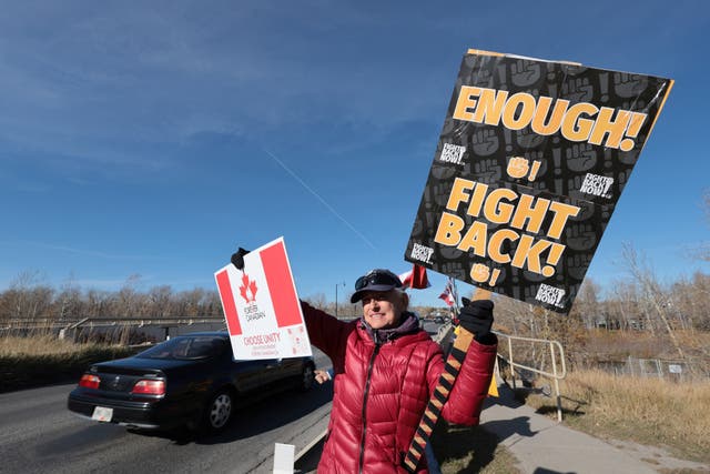 A supporter of the pro-Canada group Forever Canadian participates in an event, one day before the non-binding referendum
