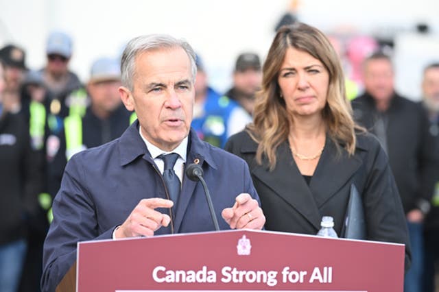 Prime Minister Mark Carney speaks as Alberta Premier Danielle Smith listens during a news conference in Fort McMurray, Alberta