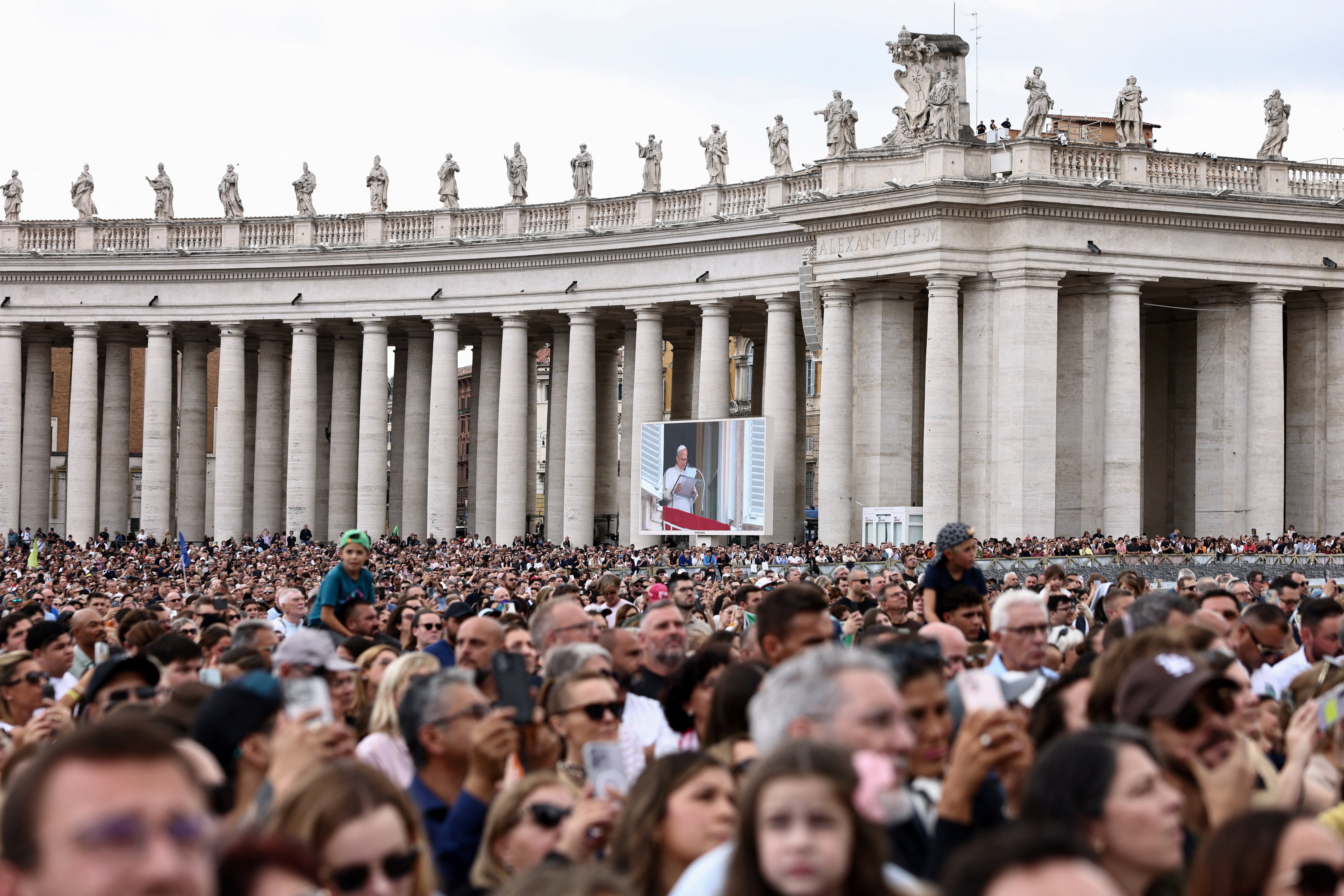 Faithful gather in St. Peter's Square as Pope Leo leads the Angelus prayer from a window of the Apostolic Palace, following his discharge from hospital after surgery for lung cancer, at the Vatican, October 18, 2026