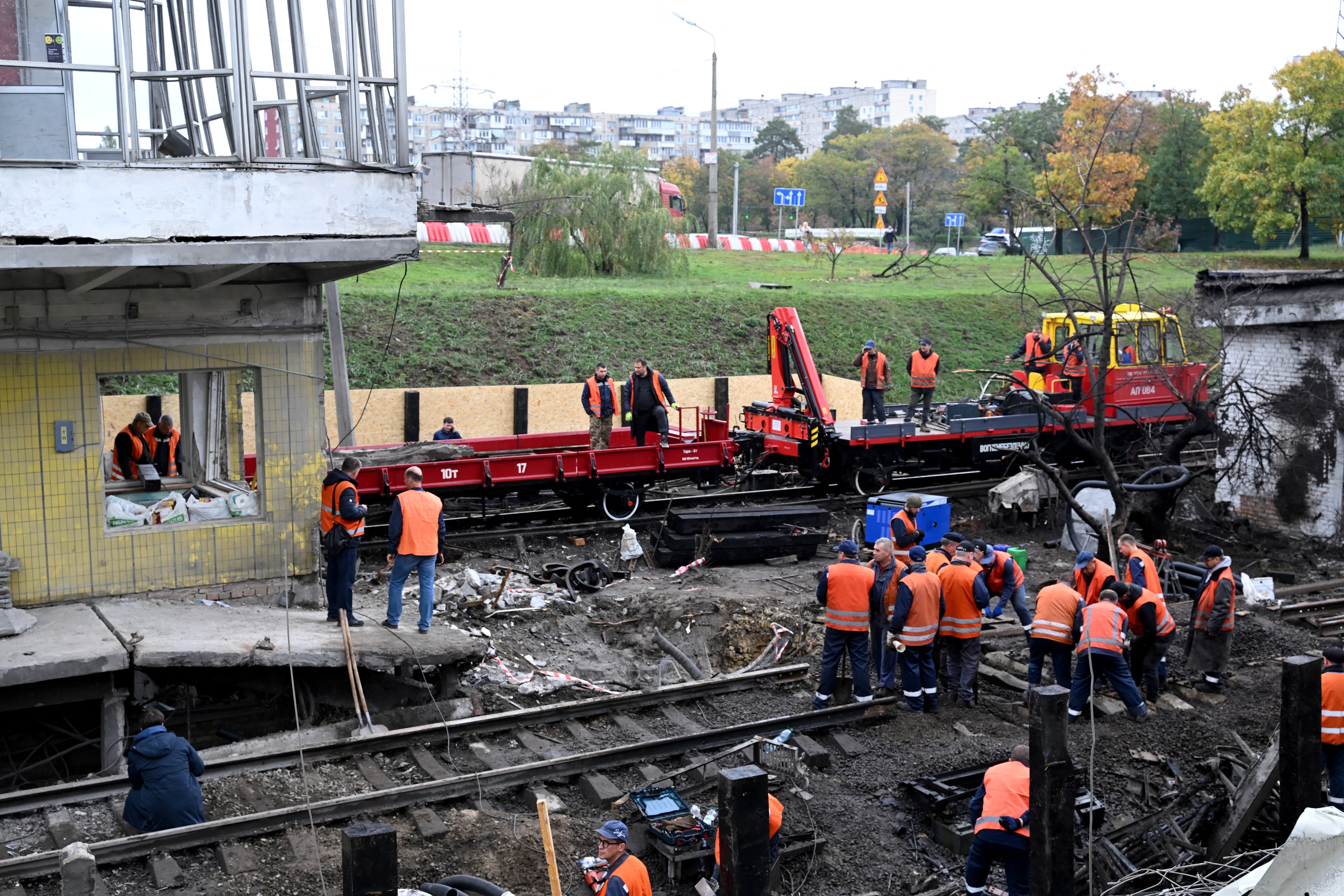 Workers clear the rubble from a met