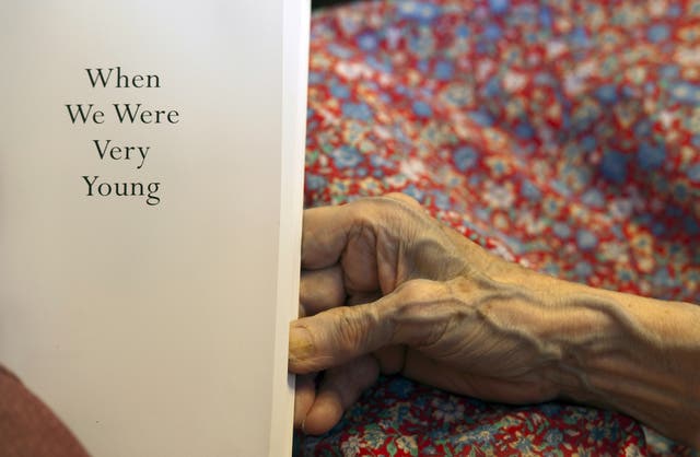 A volunteer reads to a resident suffering from dementia at a retirement home in Stratford upon Avon
