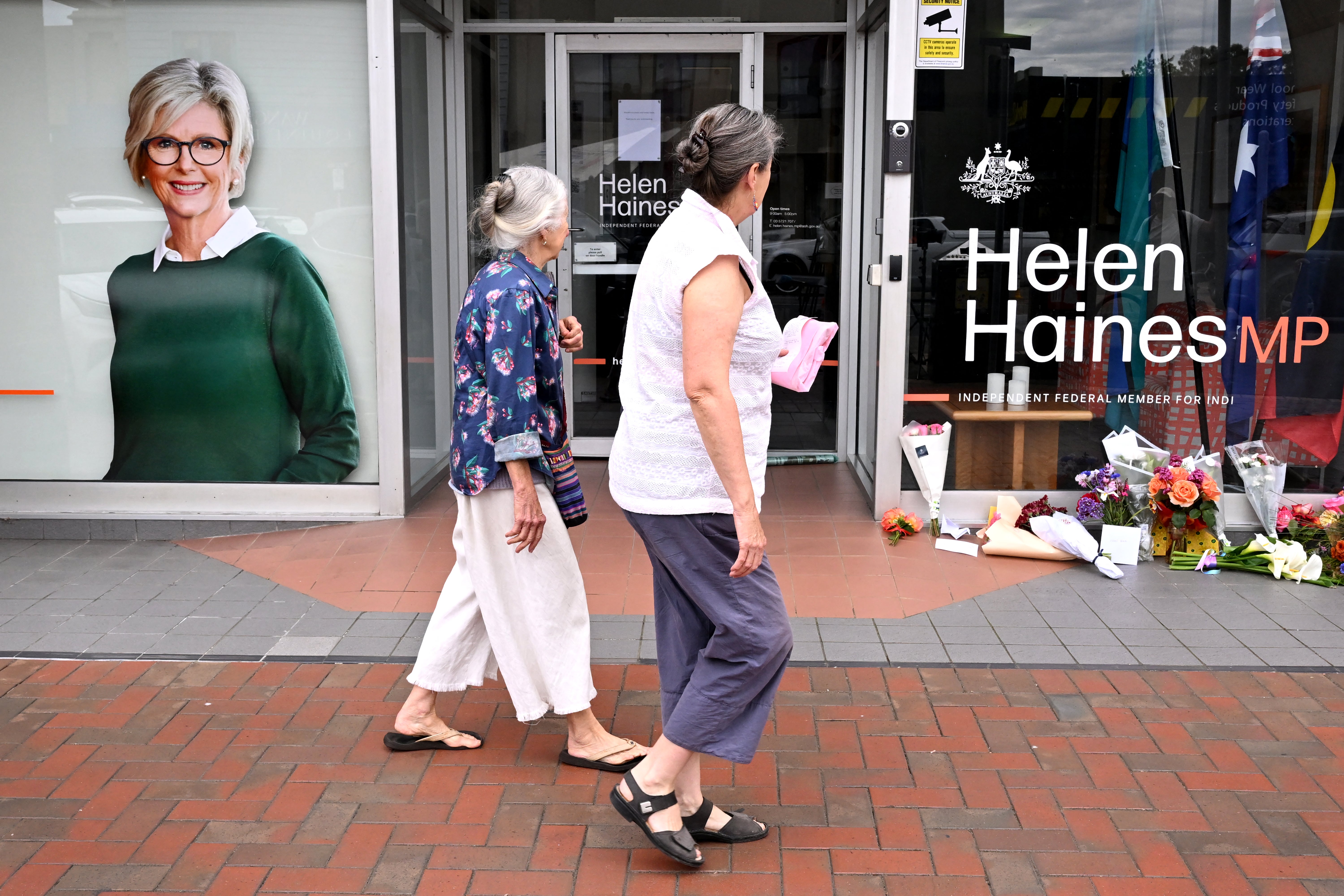 People lay flowers outside the office of Australian politician Helen Haines in the northern regional city of Wangaratta
