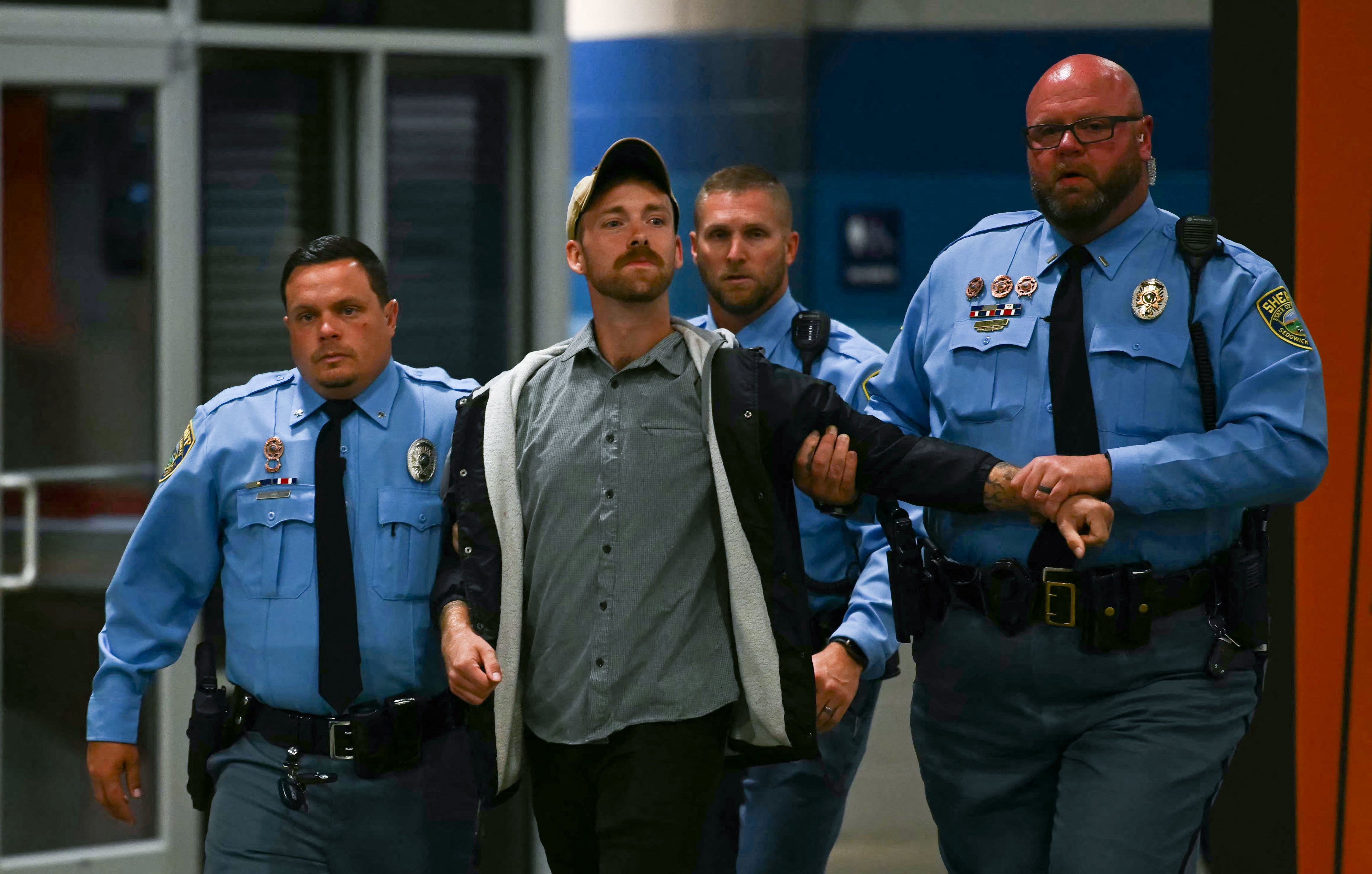 President Donald Trump has been interrupted by several demonstrators during his rally in Kansas, calling them idiots and accusing them of being paid protesters