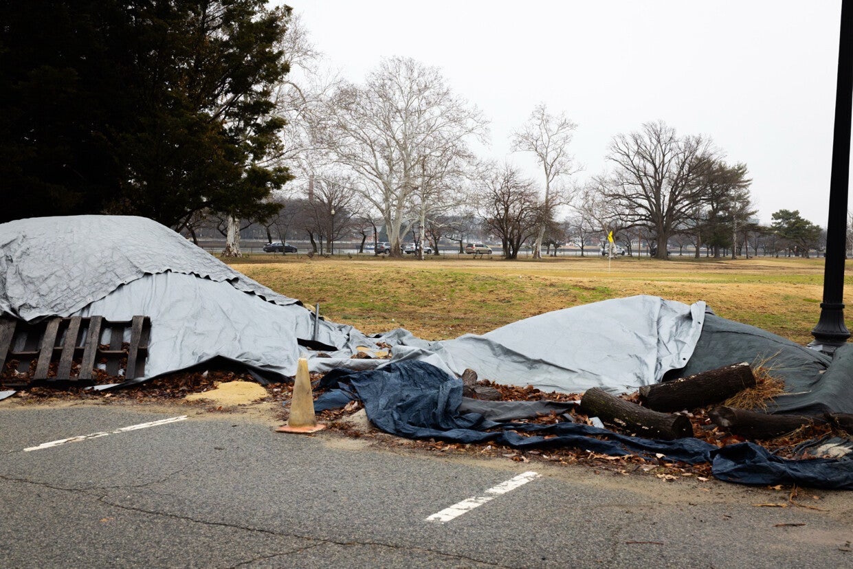 Trump shared an image of tarps in a parking lot on the 36-hole course