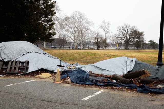 Trump shared an image of tarps in a parking lot on the 36-hole course