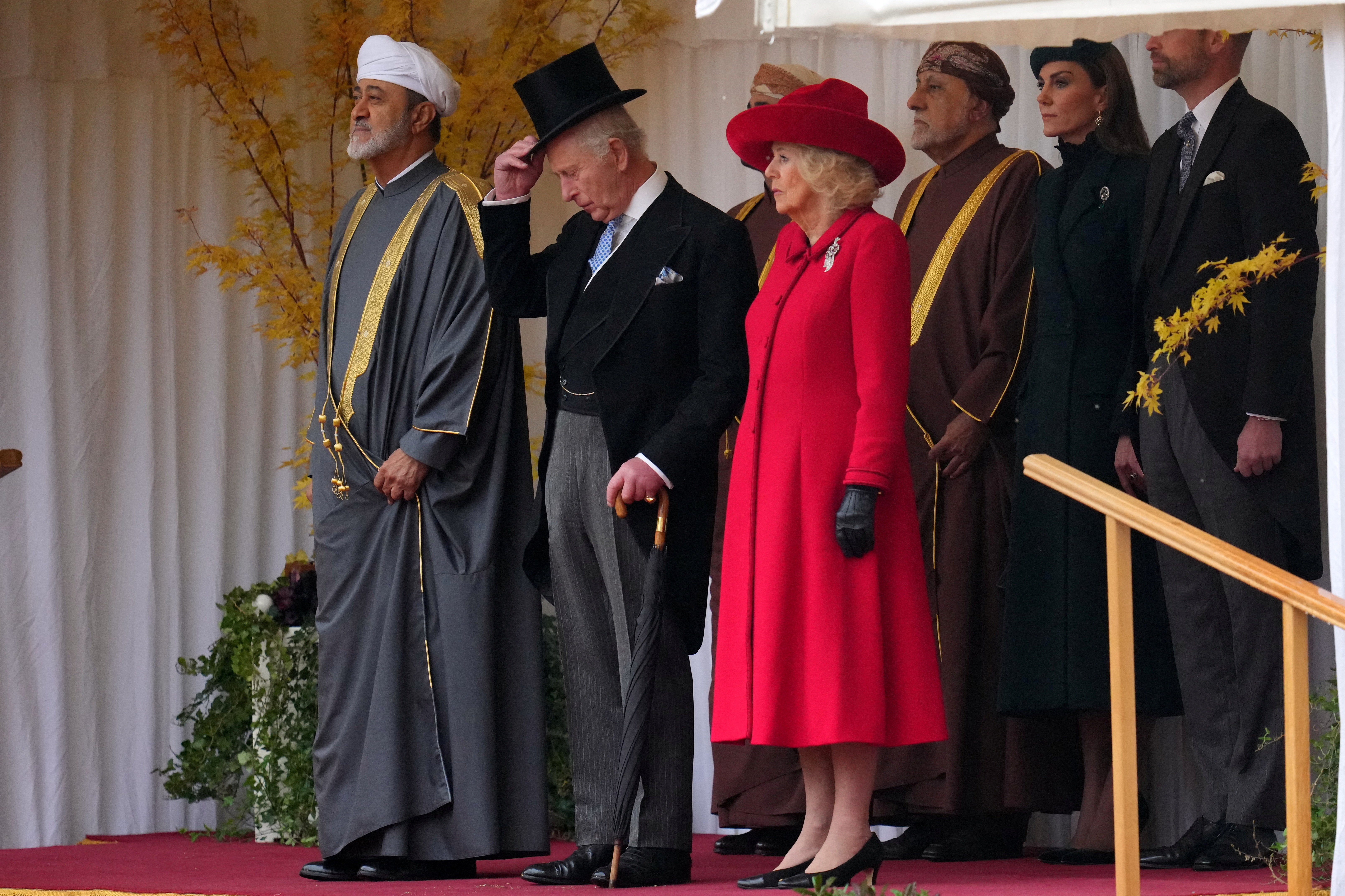 The Sultan, Charles and Camilla watch the guard of honour marching past