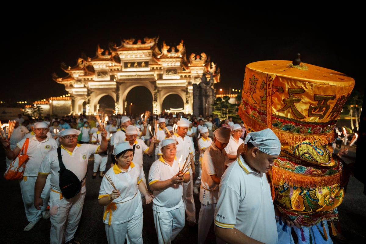 Photos show fire walks and vegetarian meals at the Nine Emperor Gods Festival