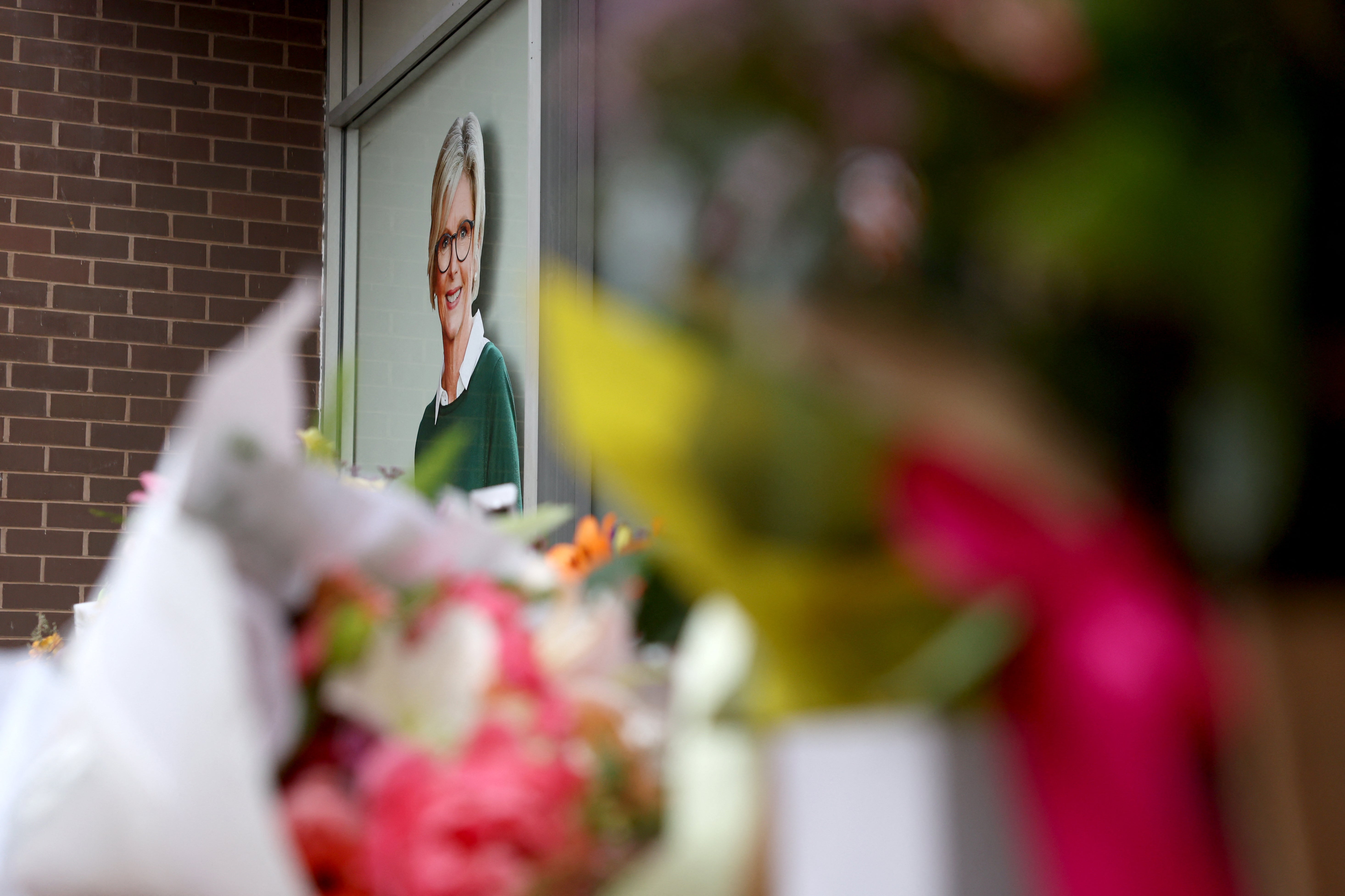 Floral tributes are placed outside the offices of Australian lawmaker Helen Haines who was critically wounded in a 'targetted' attack, in Wangaratta