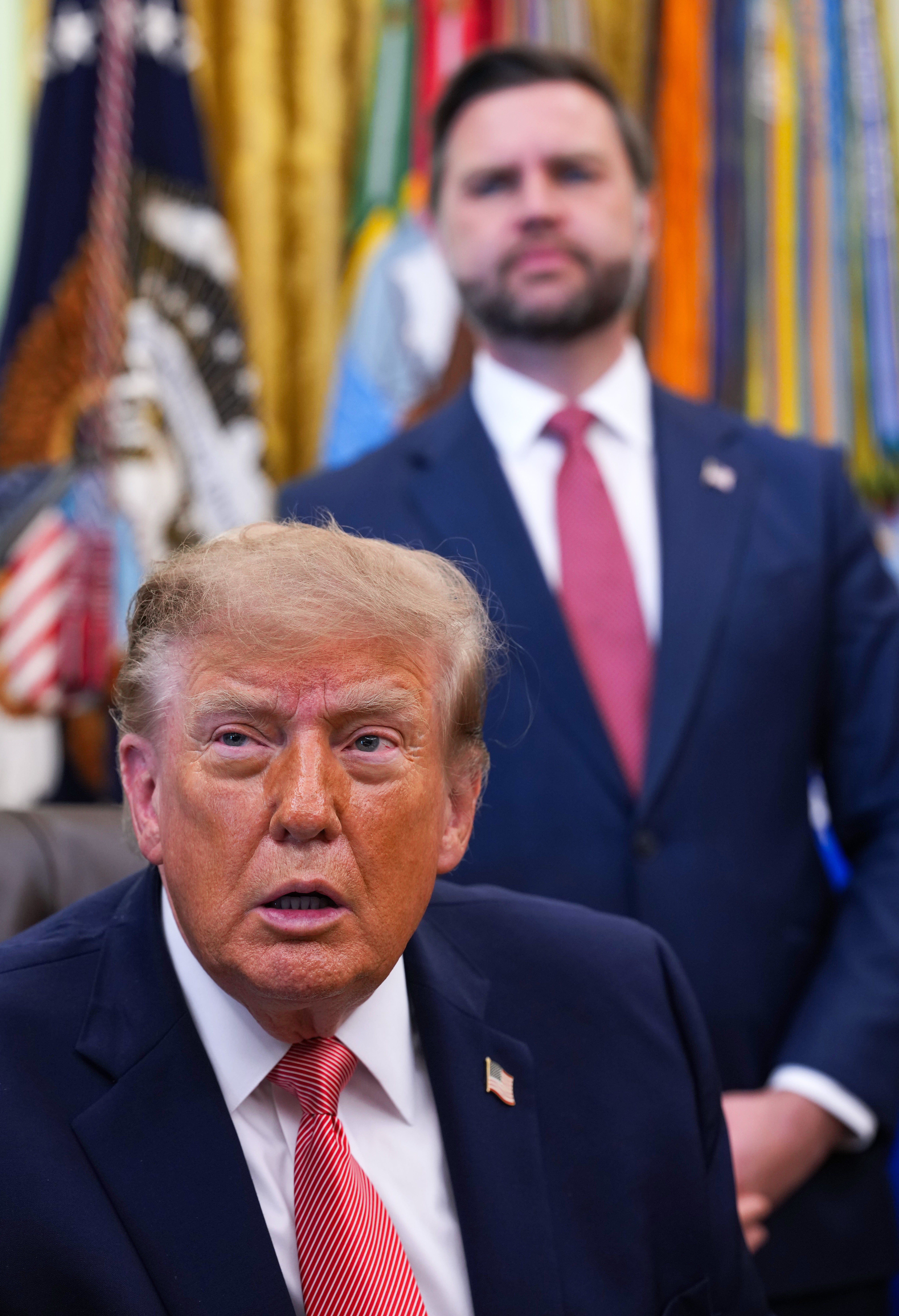President Donald Trump (L) and U.S. Vice President JD Vance attend an event in the Oval Office of the White House