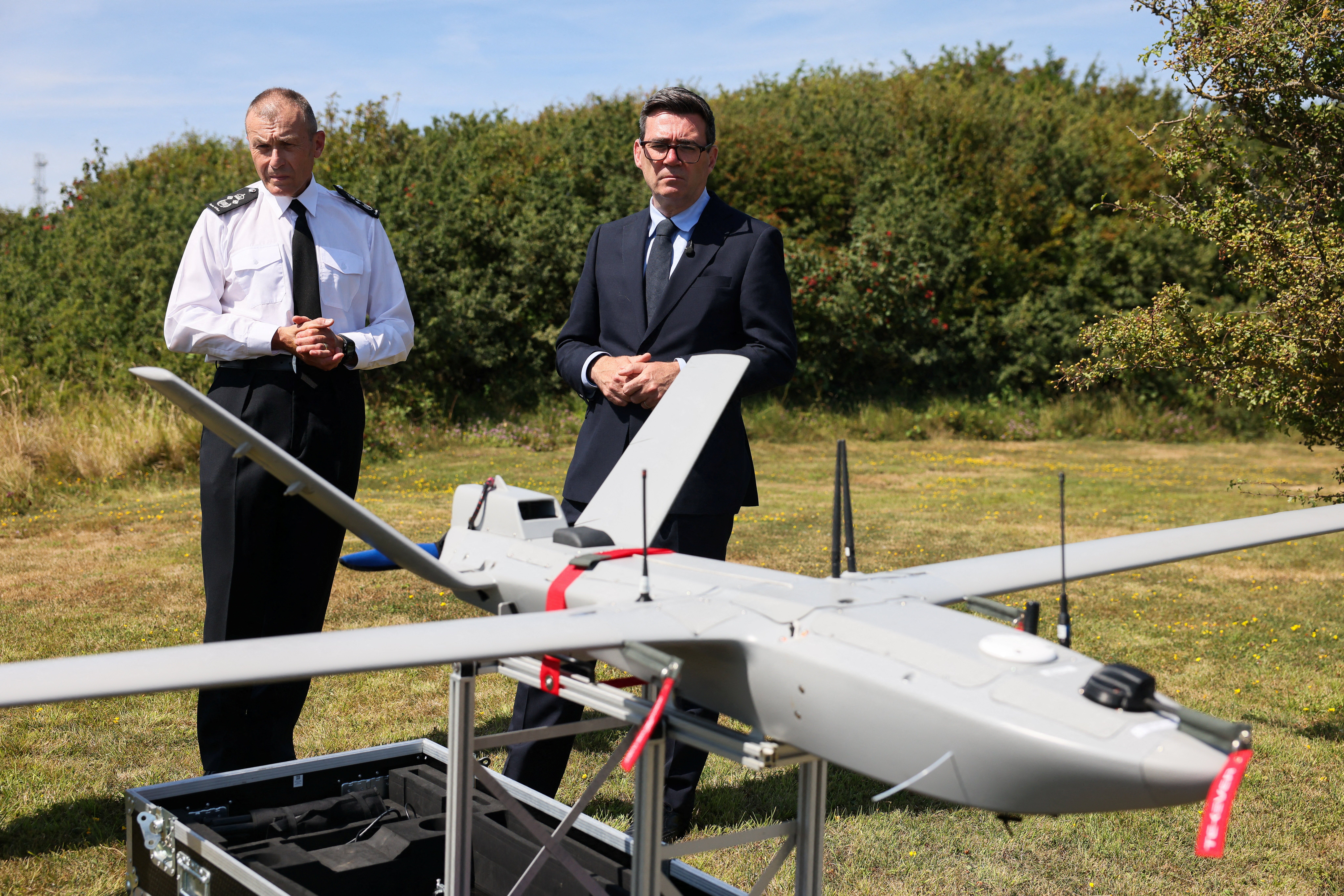 Prime Minister Andy Burnham talks with Duncan Capps, Border Security Commander (DG BSC) as he is shown a surveillance drone, during a visit to HM Coastguard Maritime Rescue Coordination Centre, in Dover, southern England, on August 2, 2026.