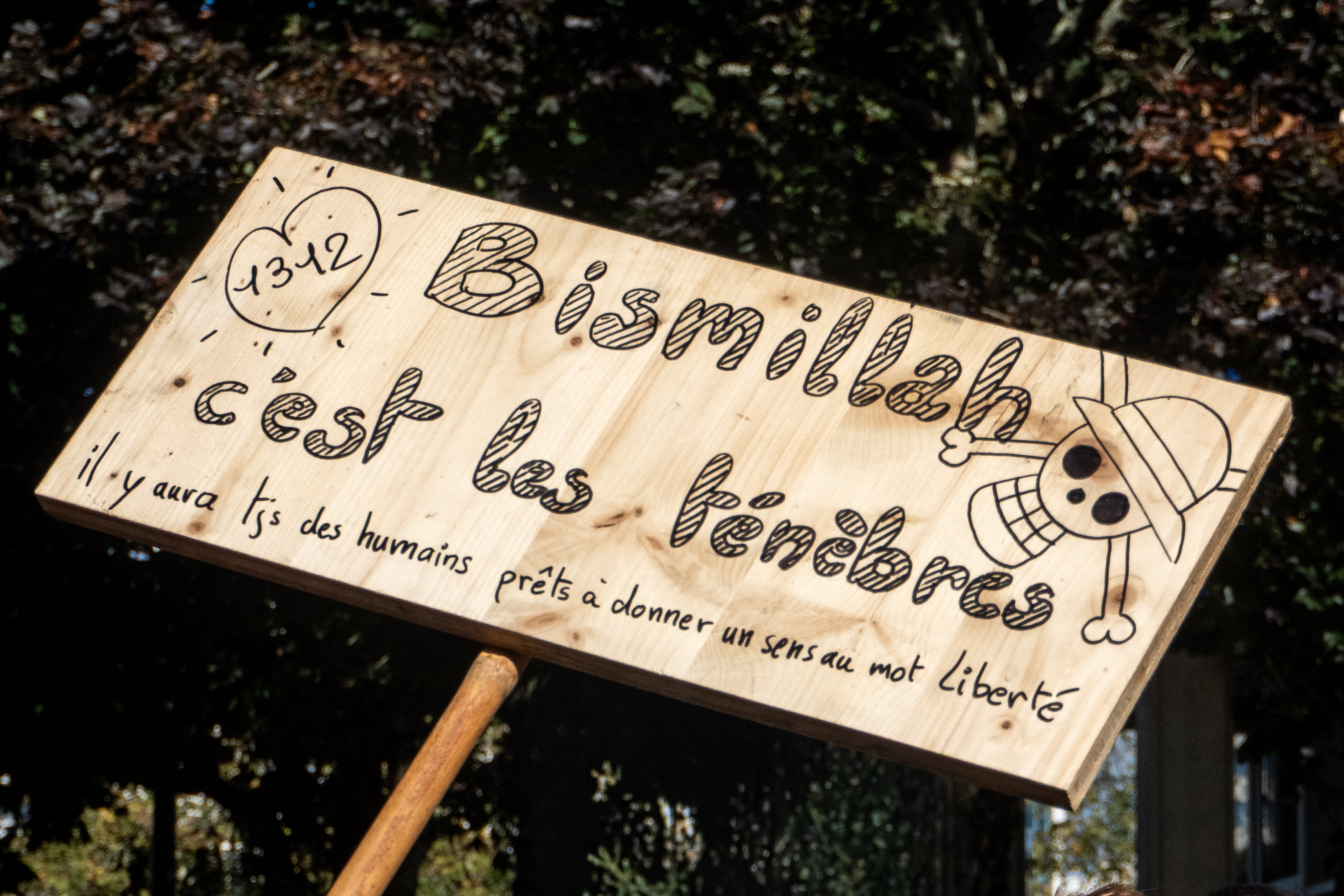 The message, which awkwardly mixes Arabic and French, has been spotted at multiple protests (AFP/Getty)