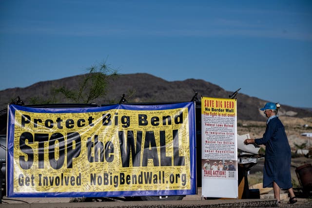 A woman protests the plans by US President Donald Trump's administration to build a section of the border wall at the Big Bend National Park in Study Butte, Texas, on August 15, 2026