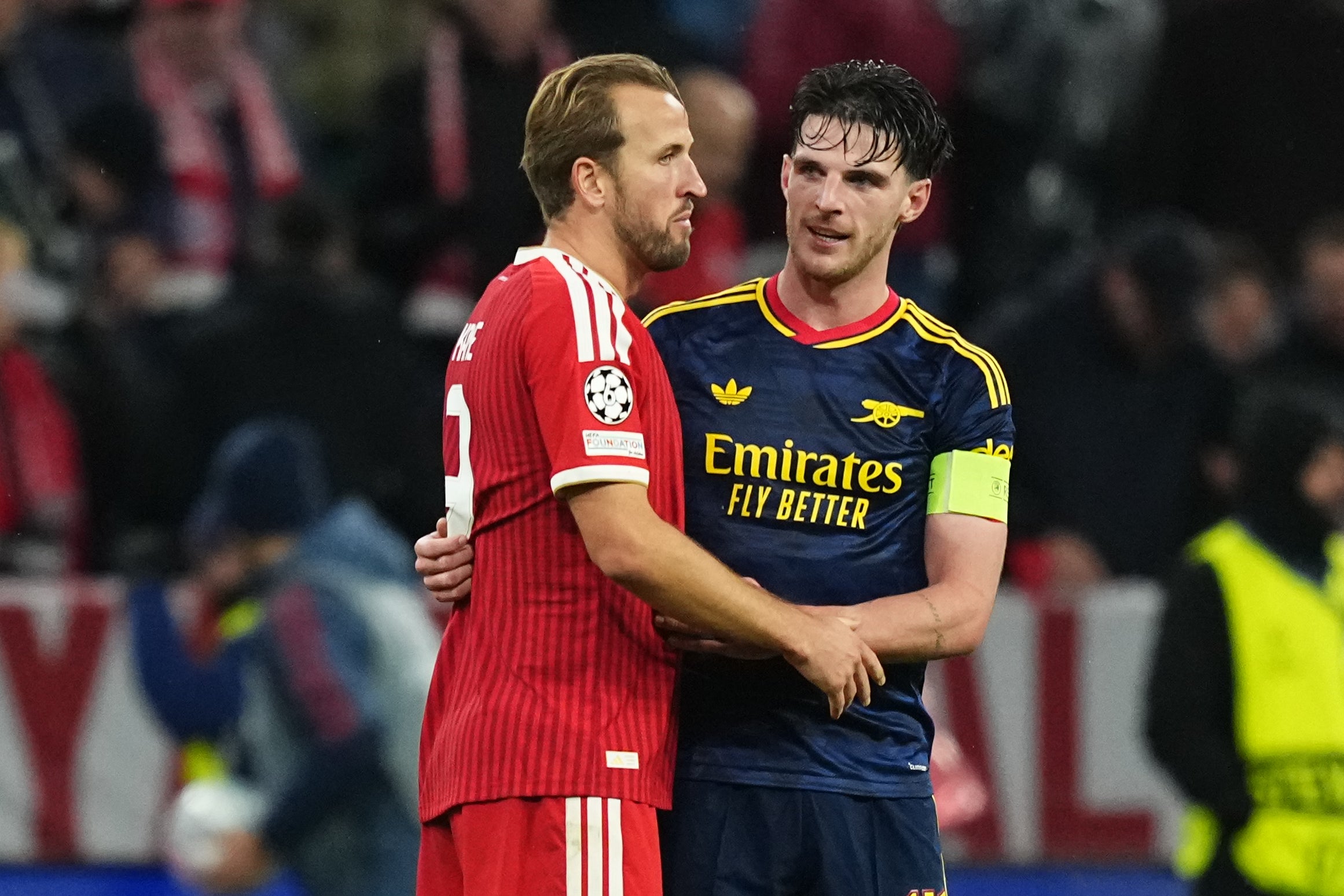 Harry Kane (left) and Declan Rice embrace after full-time at the Allianz Arena