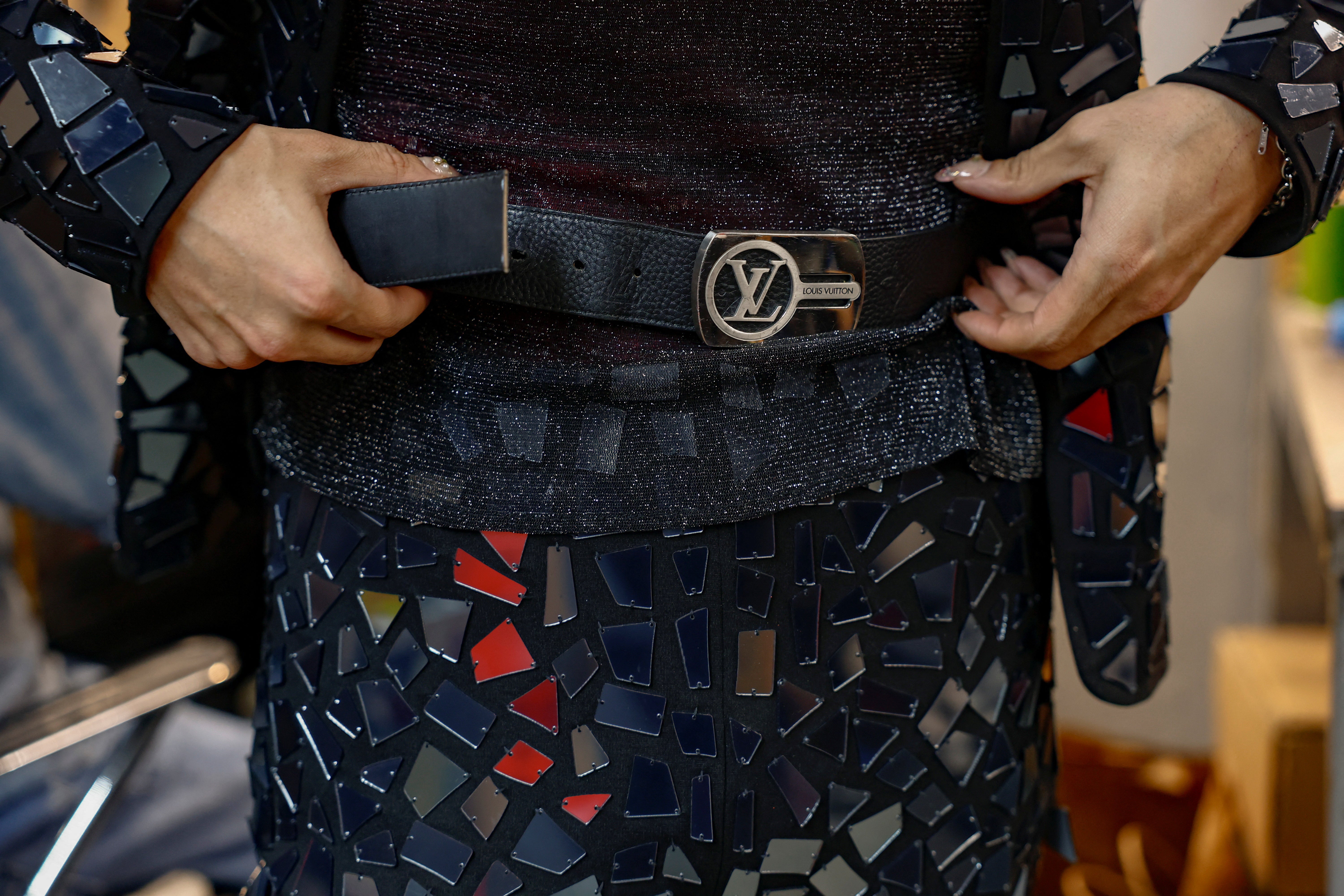 CJ Burgos, director of client relations at Jim's Cobbler Concierge, wears a shortened belt