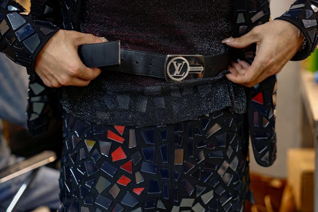 CJ Burgos, director of client relations at Jim's Cobbler Concierge, wears a shortened belt