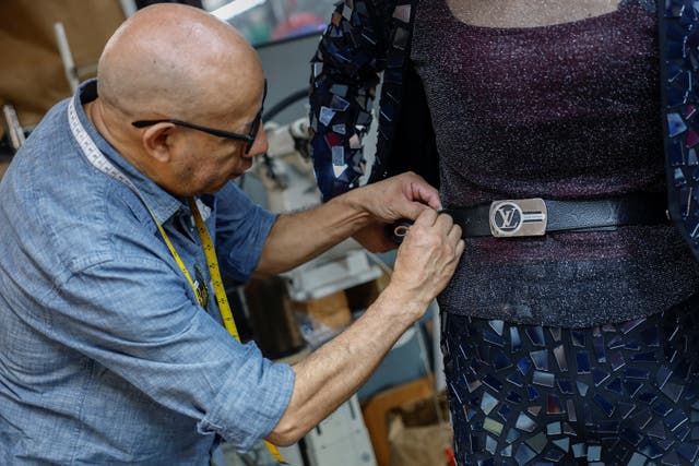 Angel Luciano marks a belt for alteration for CJ Burgos, director of client relations at Jim's Cobbler Concierge, at the store in New York City