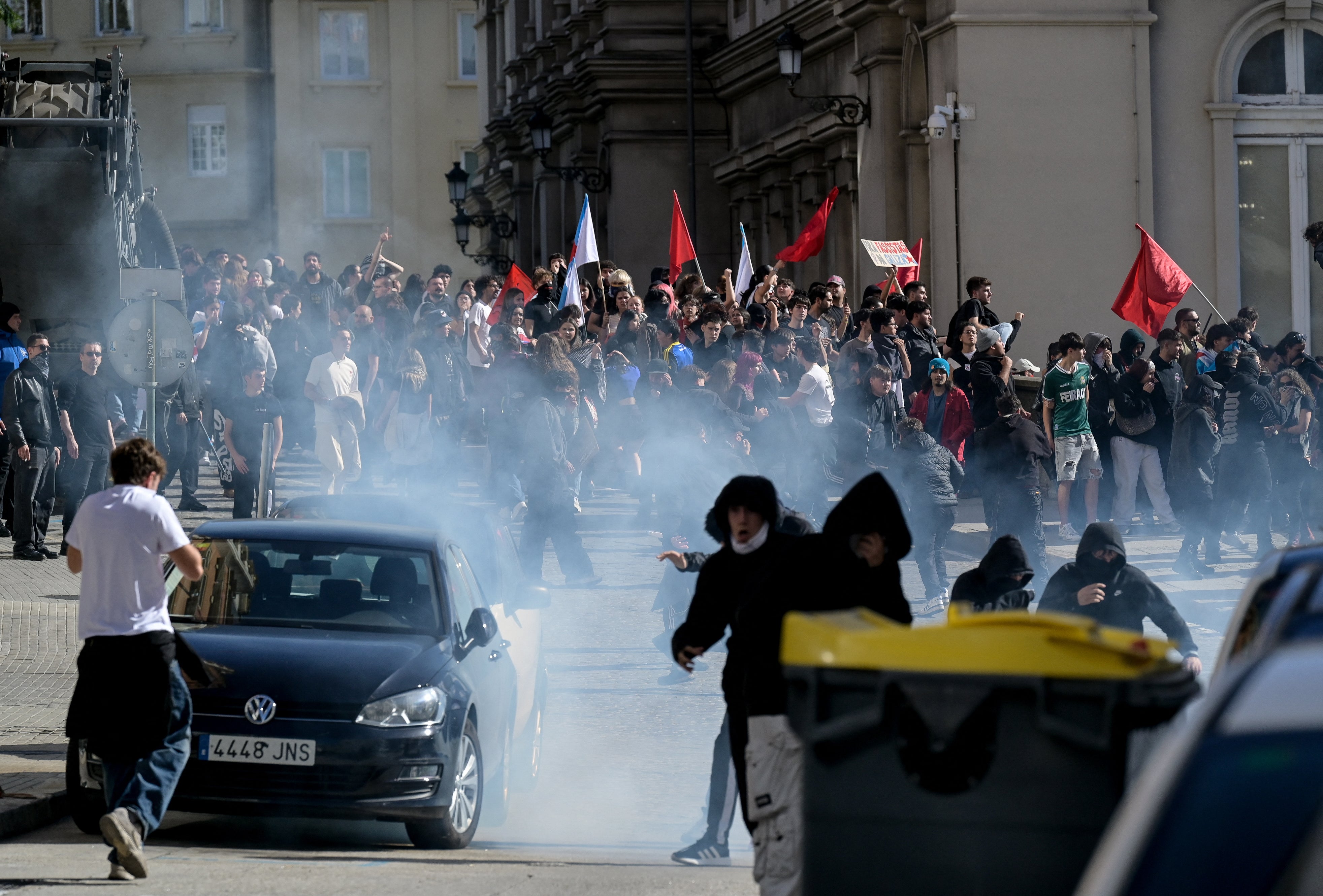 Protesters react to teargas as they take part in a demonstration in the city on Wednesday