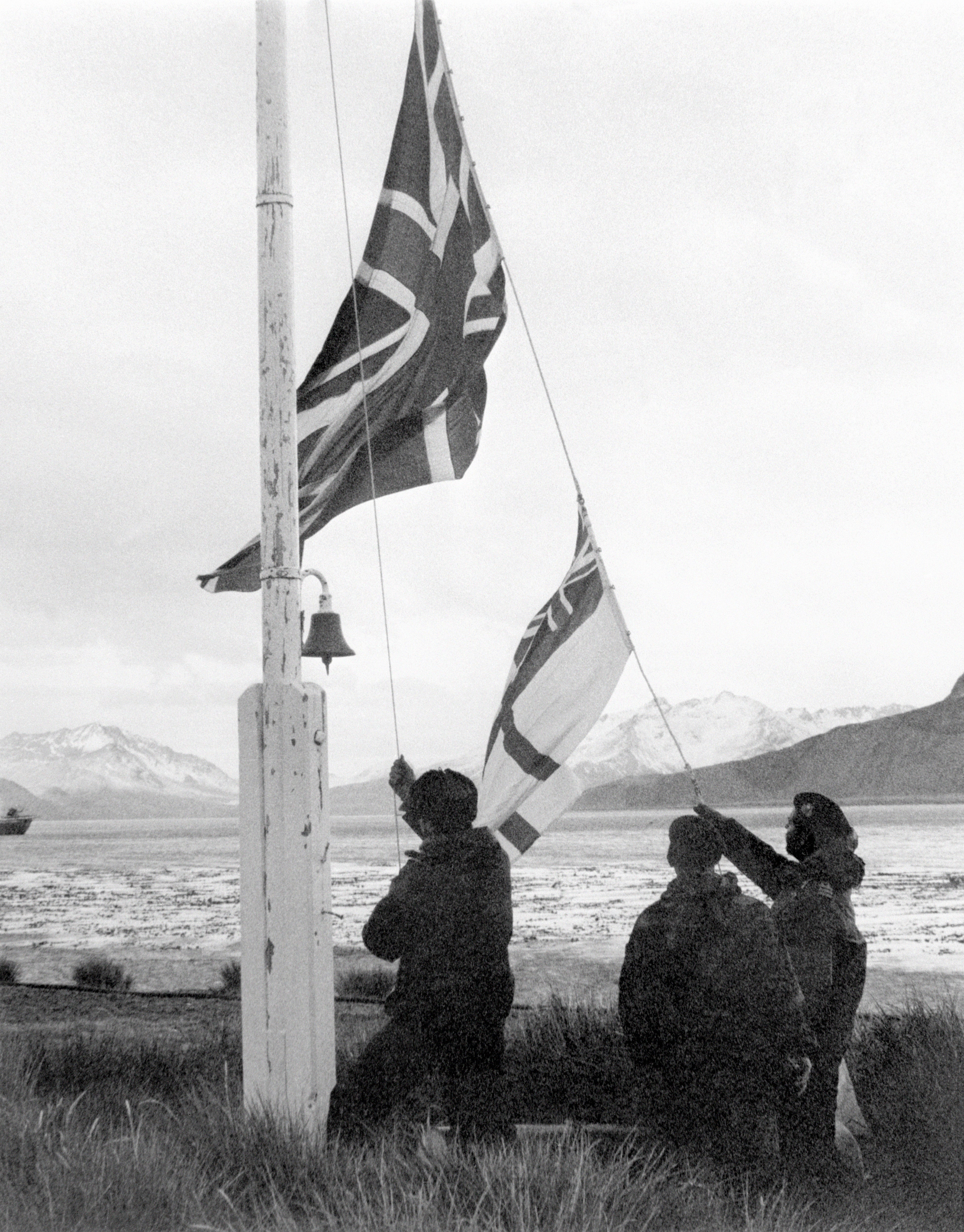 A Union Flag and white ensign being raised on South Georgia after the island's recapture by the British in May 1982