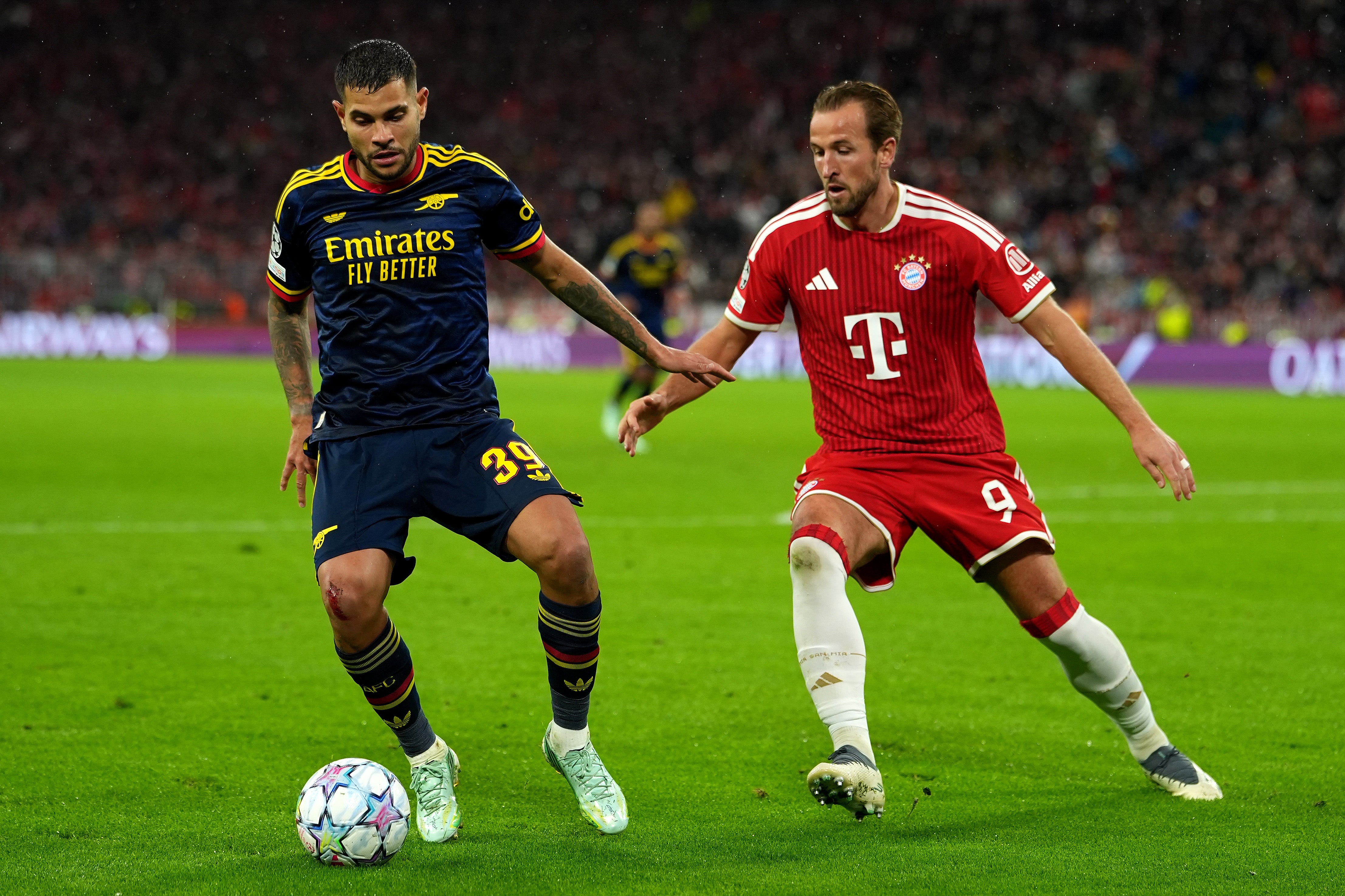 Bruno Guimaraes of Arsenal is challenged by Harry Kane of FC Bayern Munich