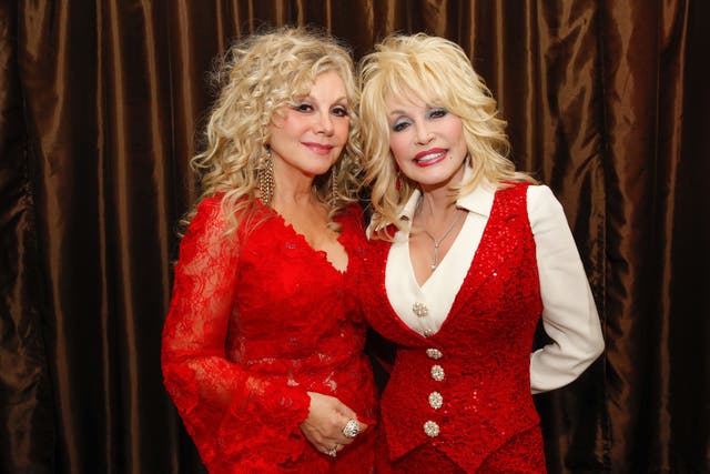 Dolly Parton’s sister, Stella Parton (left, with the late country music star) has warned her followers to double-check their ballots after she claimed a voting machine in Tennessee repeatedly changed her vote to Republican