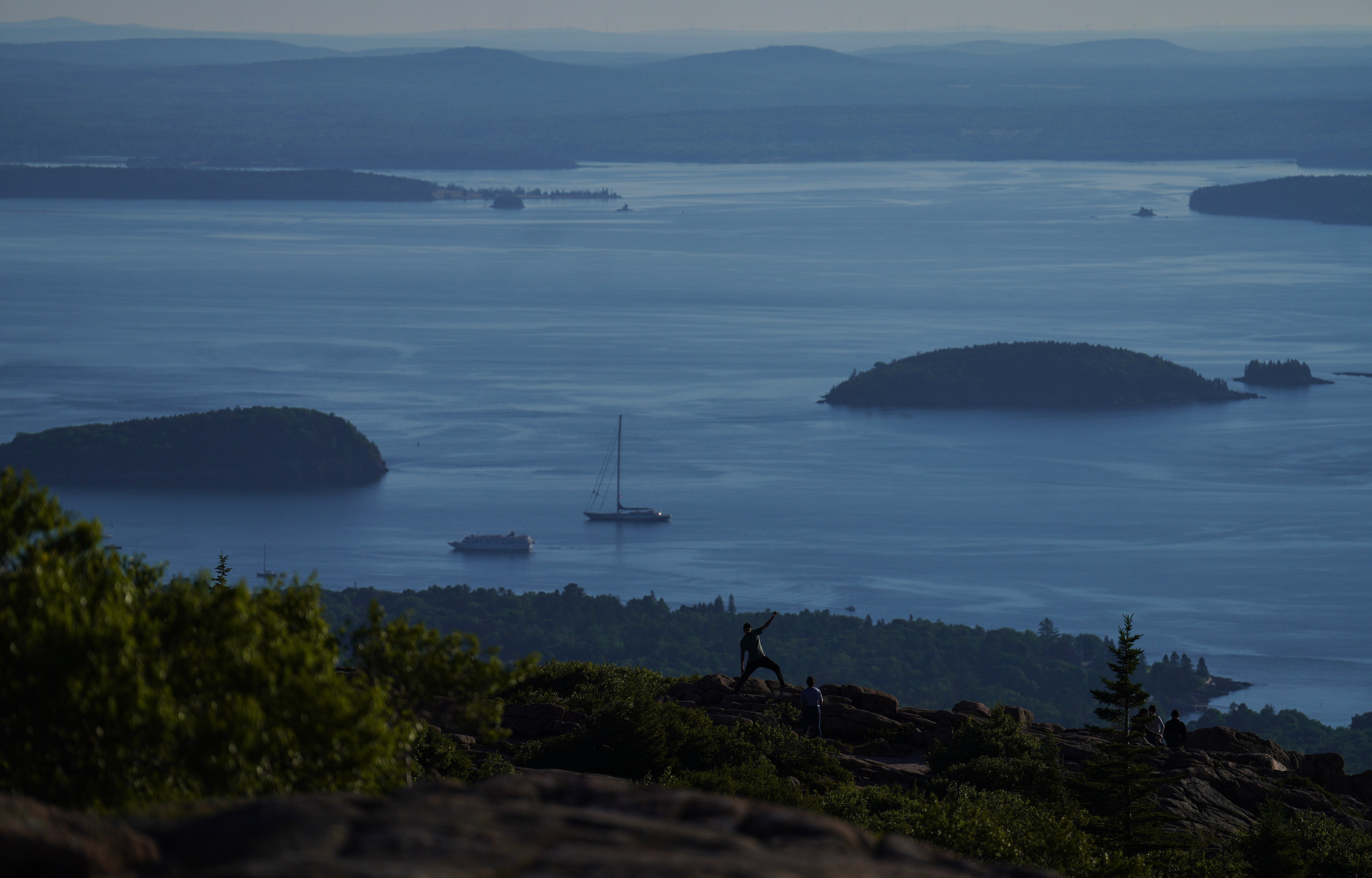 Visitors pose for photos at the summit of Cadillac Mountain in Acadia National Park in Maine