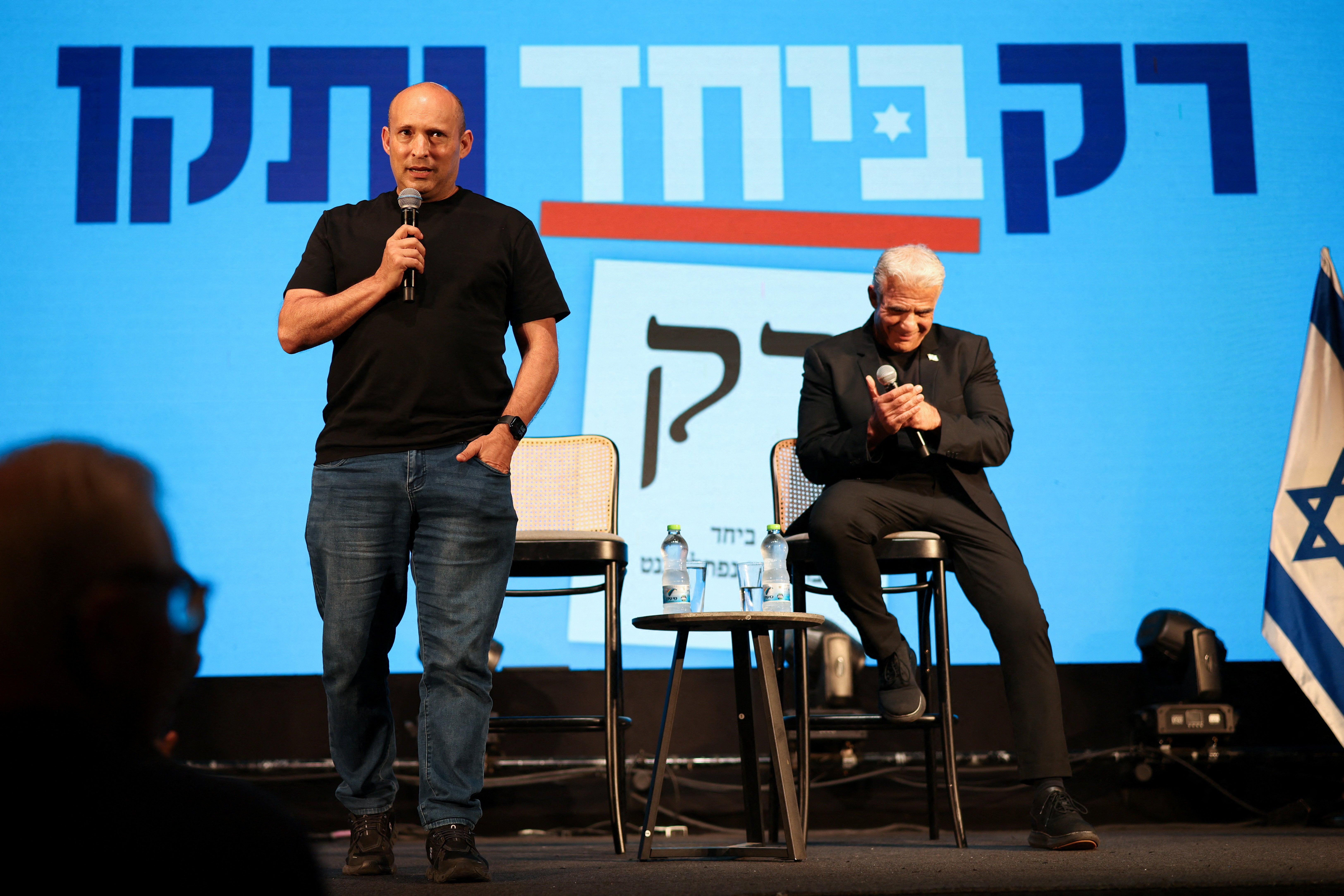 Former prime ministers Naftali Bennett (left) and Yair Lapid attend an event for their B'Yachad party