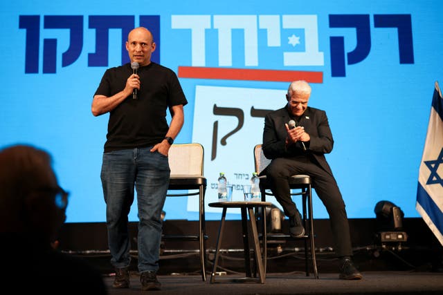Former prime ministers Naftali Bennett (left) and Yair Lapid attend an event for their B'Yachad party