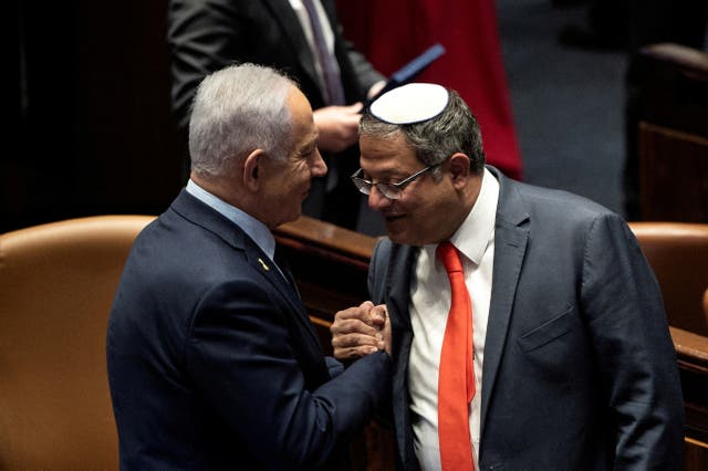 Netanyahu and Itamar Ben-Gvir shake hands in the Knesset last year