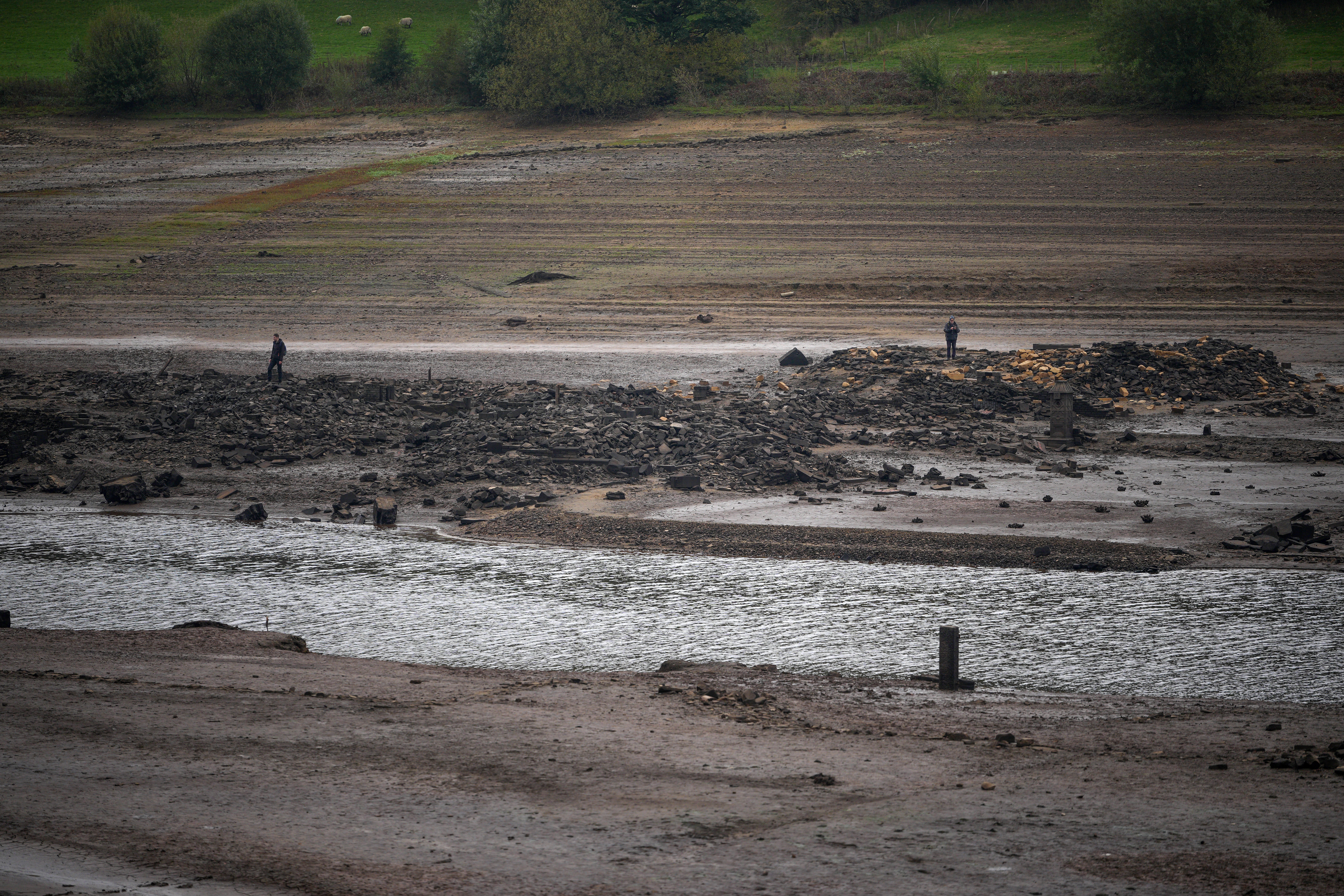 Local authorities cautioned that the newly exposed reservoir bed presents dangers to those who may attempt to walk on it