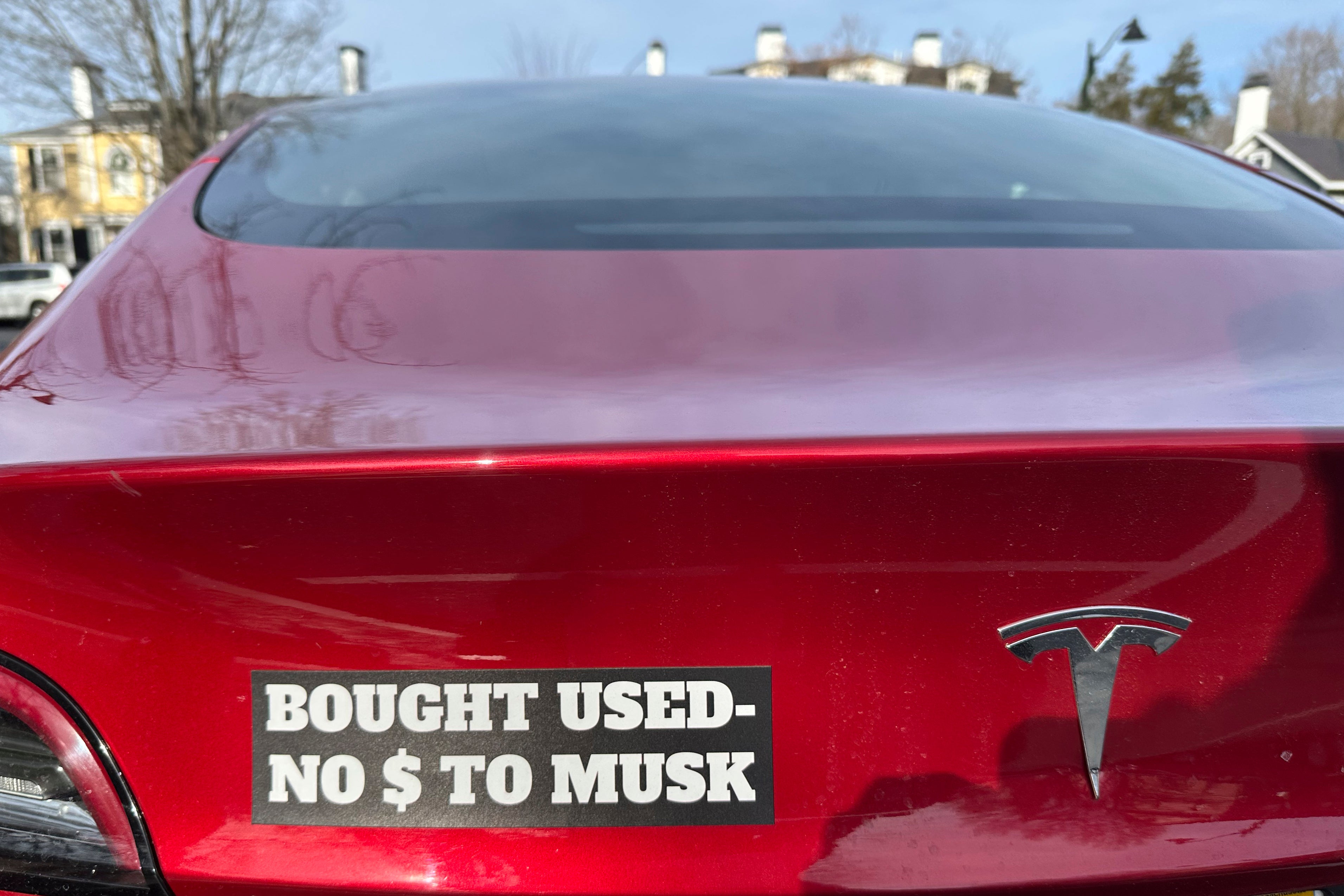 A Tesla vehicle displays a sticker referring to the car's purchase on Sunday, Dec. 15, 2024, in Concord, Mass.