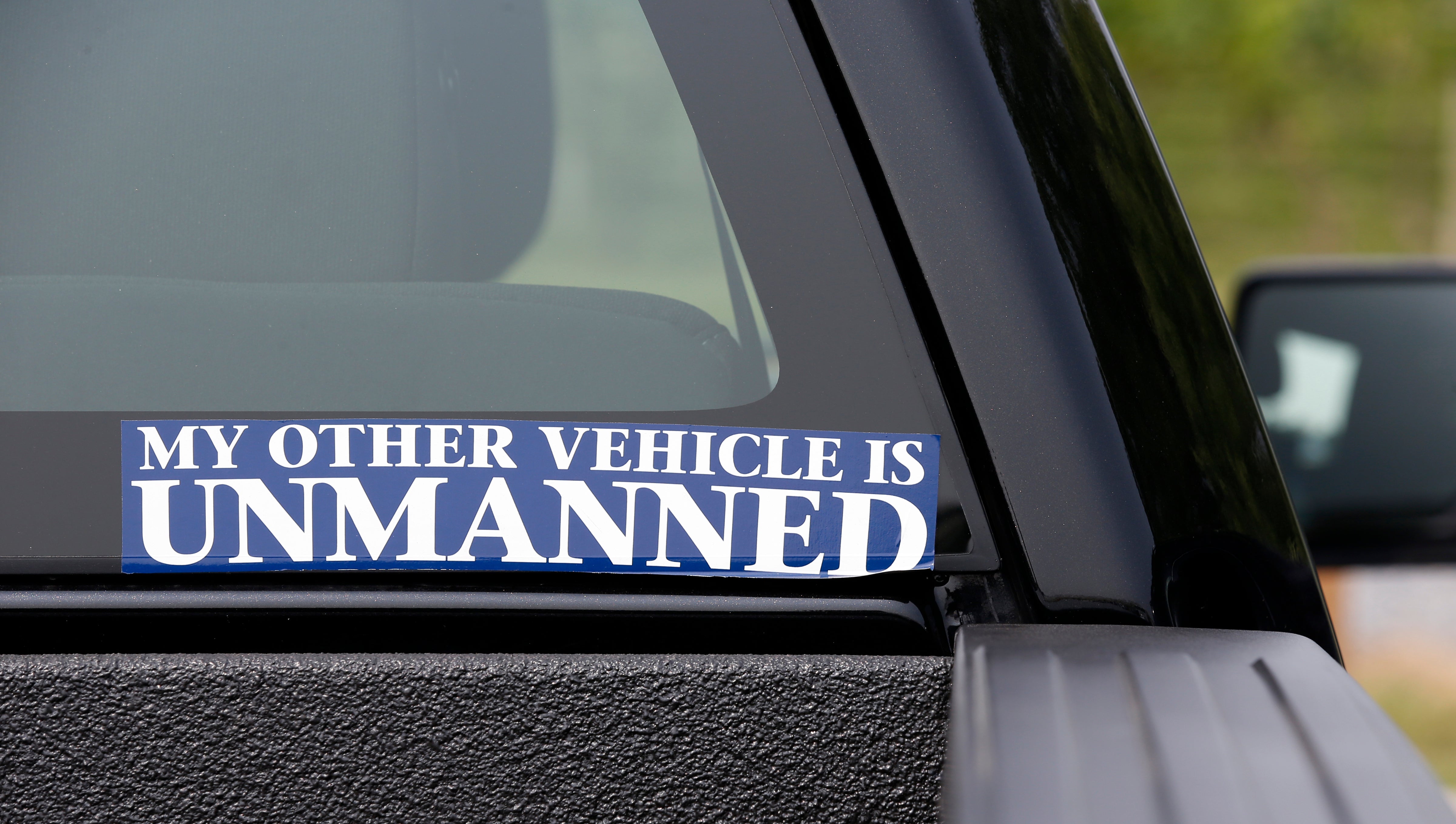 A bumper sticker displayed on a car during a drone demonstration at a farm and winery, June 11, 2015 in Cordova, Md.