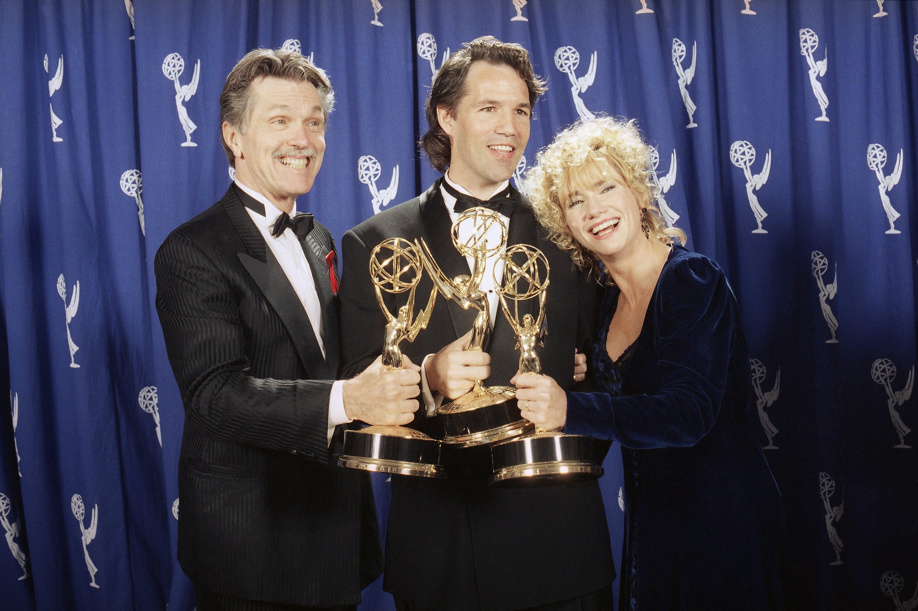 Picket Fences creator David E. Kelley (center) poses with actors Tom Skerritt and Kathy Baker after the show won best drama series during the 45th annual Emmy Awards in Pasadena, Calif., on Sept. 19, 1993