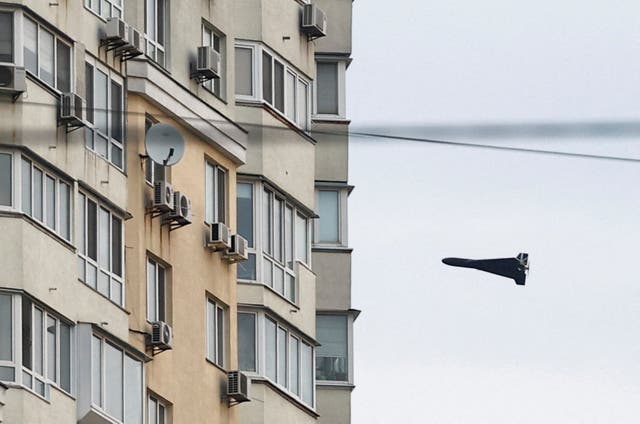 A Russian Geran 2 kamikaze drone flies next to a building, in Russia's attack on Ukraine, in Kyiv, Ukraine, April 16