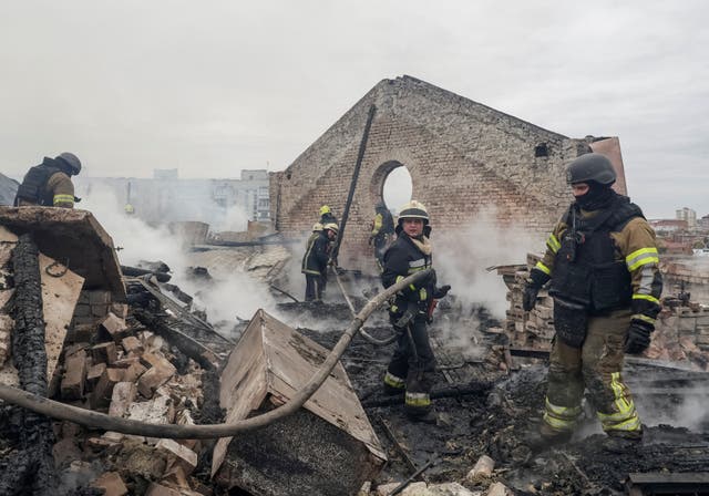 Firefighters work at the site of an office building damaged during a Russian jet drone strike in Kharkiv, Ukraine, October 23, 2026