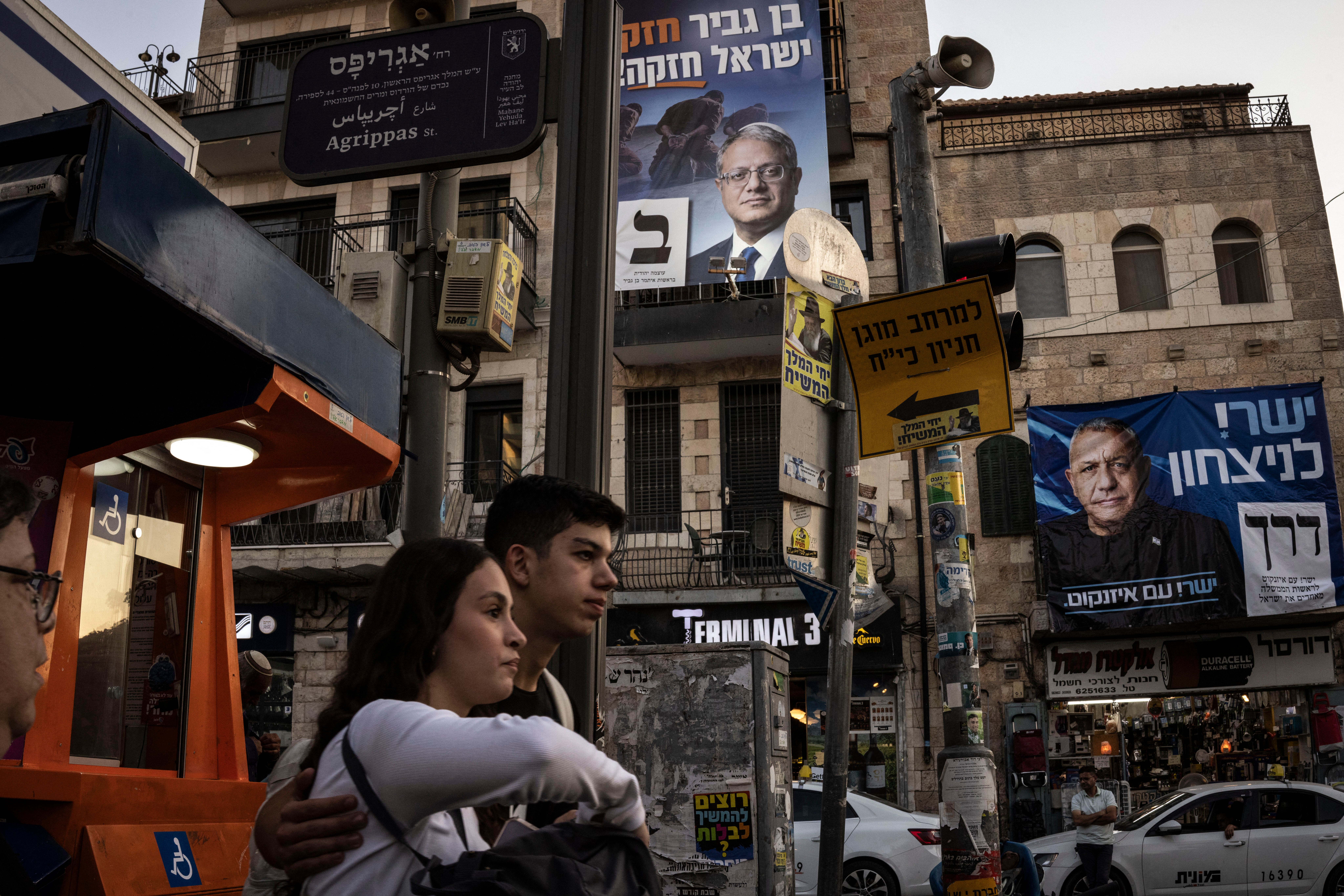 People walk past election campaign banners in the Ben Yehuda Market area of Jerusalem on October 22, 2026