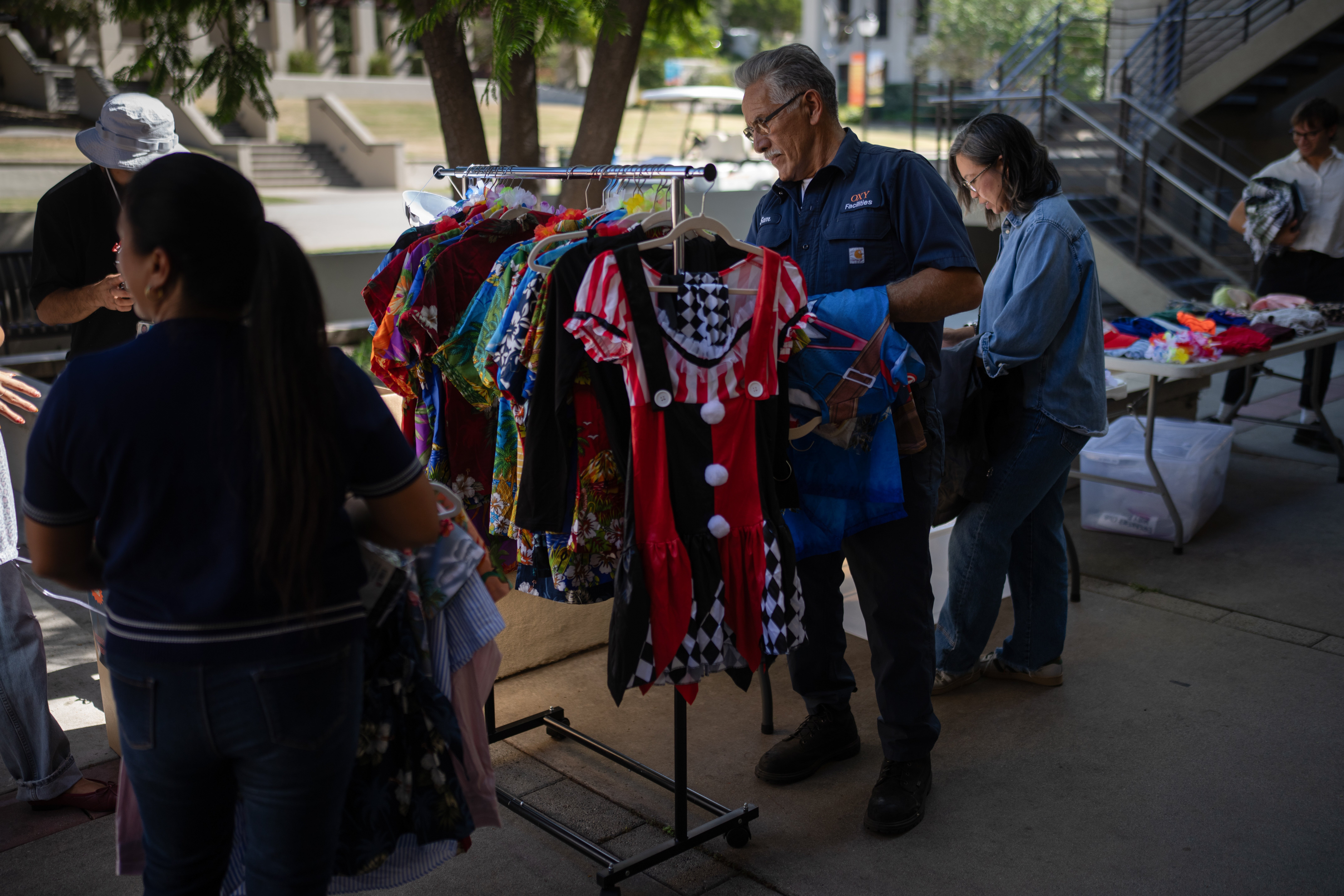Samuel Hernandez, center, looks for a costume for his grandson