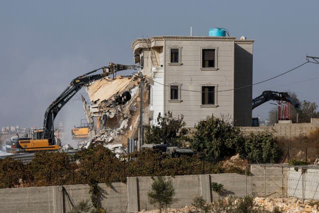 Israeli machinery demolishes a Palestinian house following a shooting attack in Hebron
