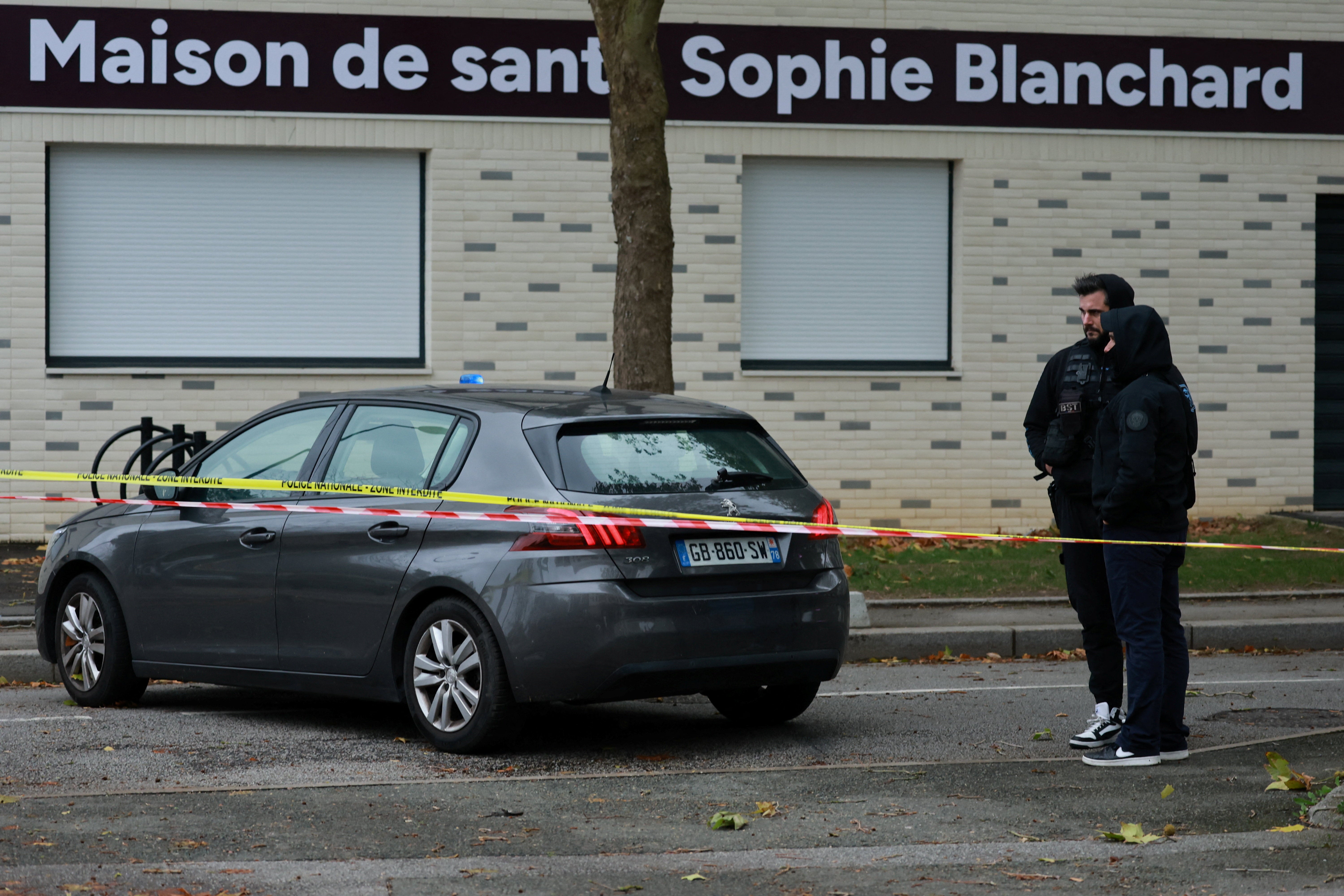 French police work at the scene after a drive-by shooting that killed one person and injured several others in Trappes, in the Yvelines area