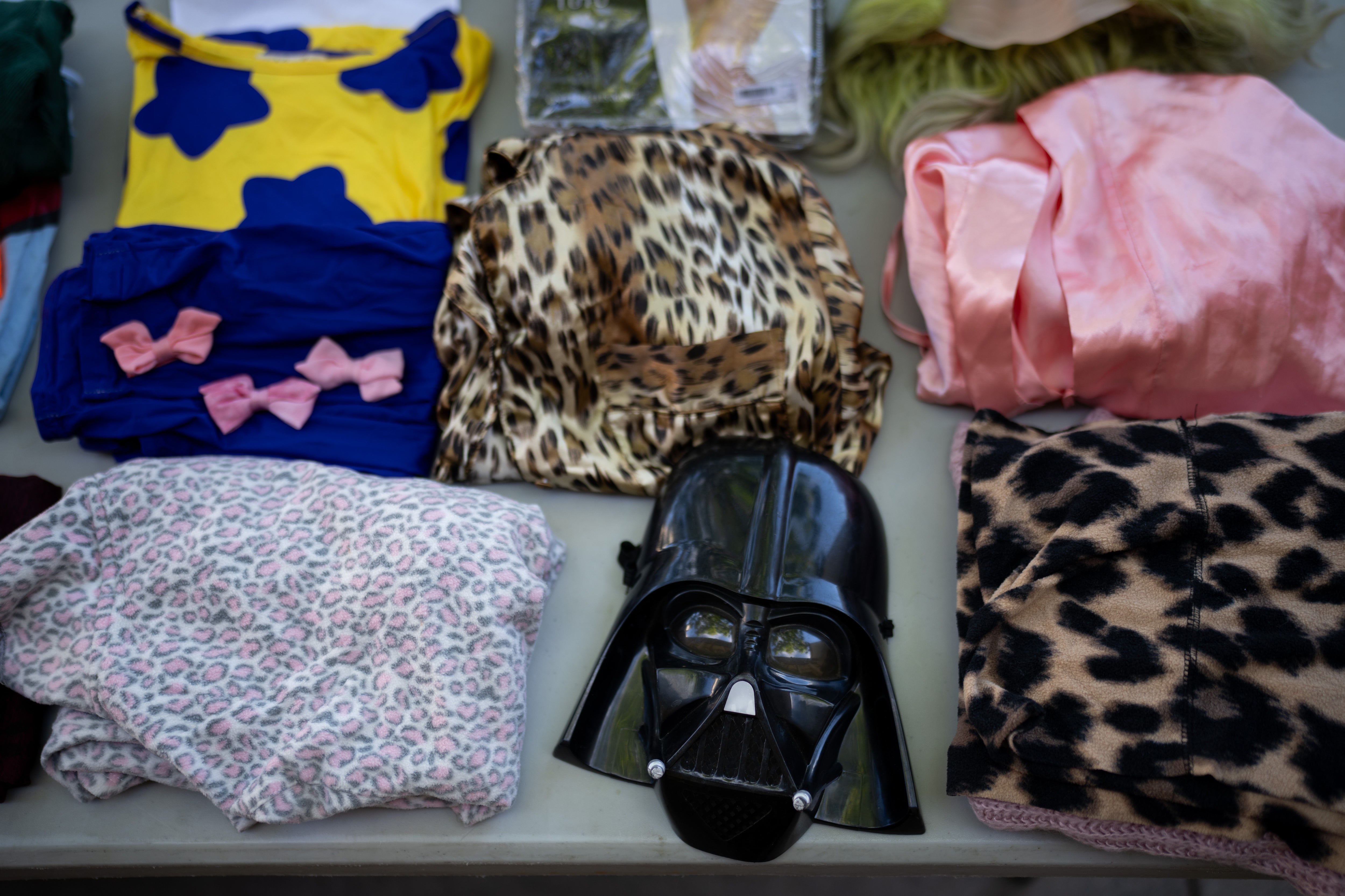 <p>Halloween costumes and accessories displayed during a Halloween costume swap</p>