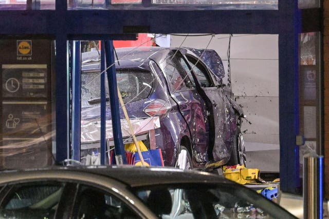 A large police cordon around a Lidl supermarket in Wolverhampton after a car crashed through the entrance, killing a man
