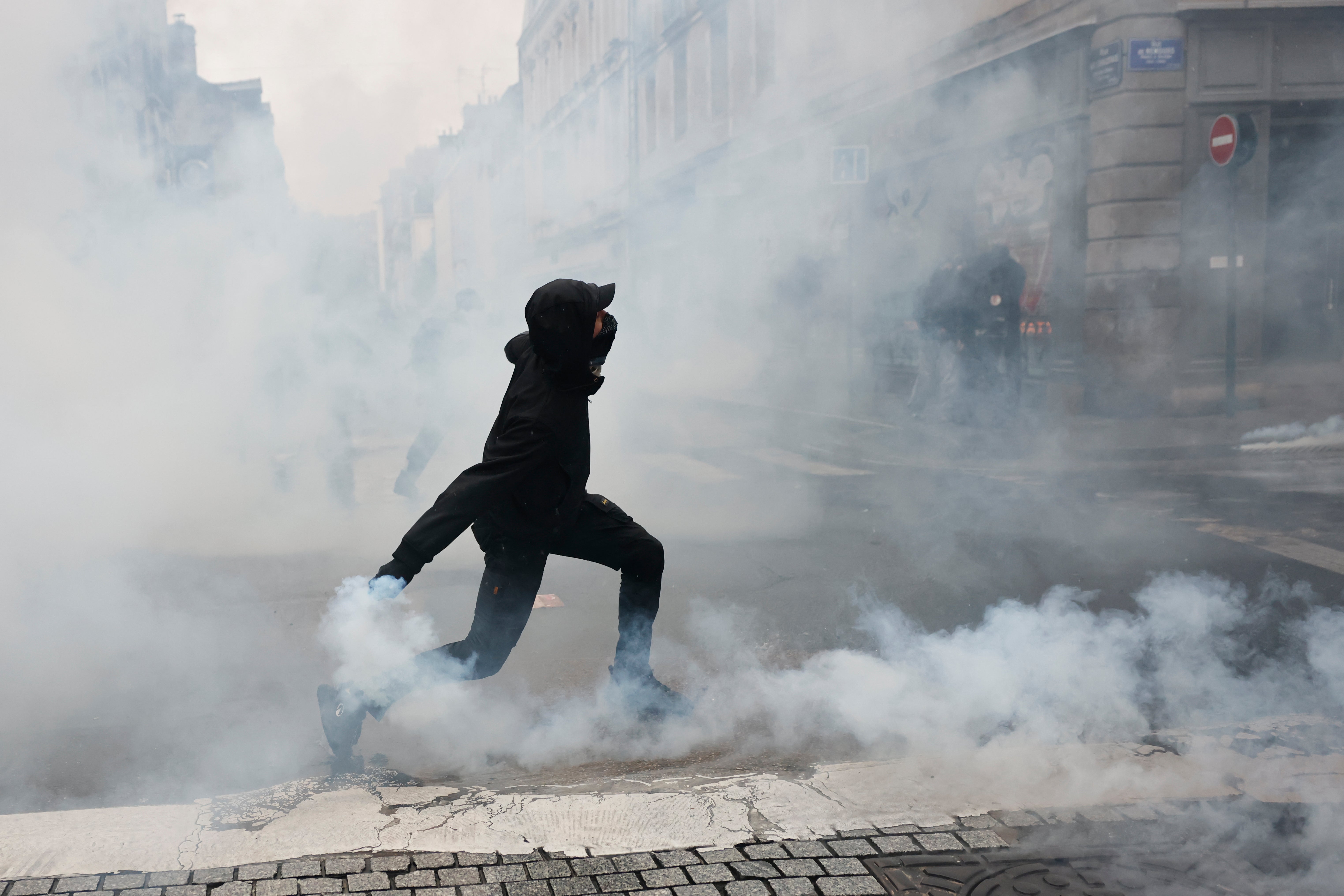 A protester throws a teargas canister to police after a demonstration against rising living costs in Rennes, France, Saturday, 24 October 2026