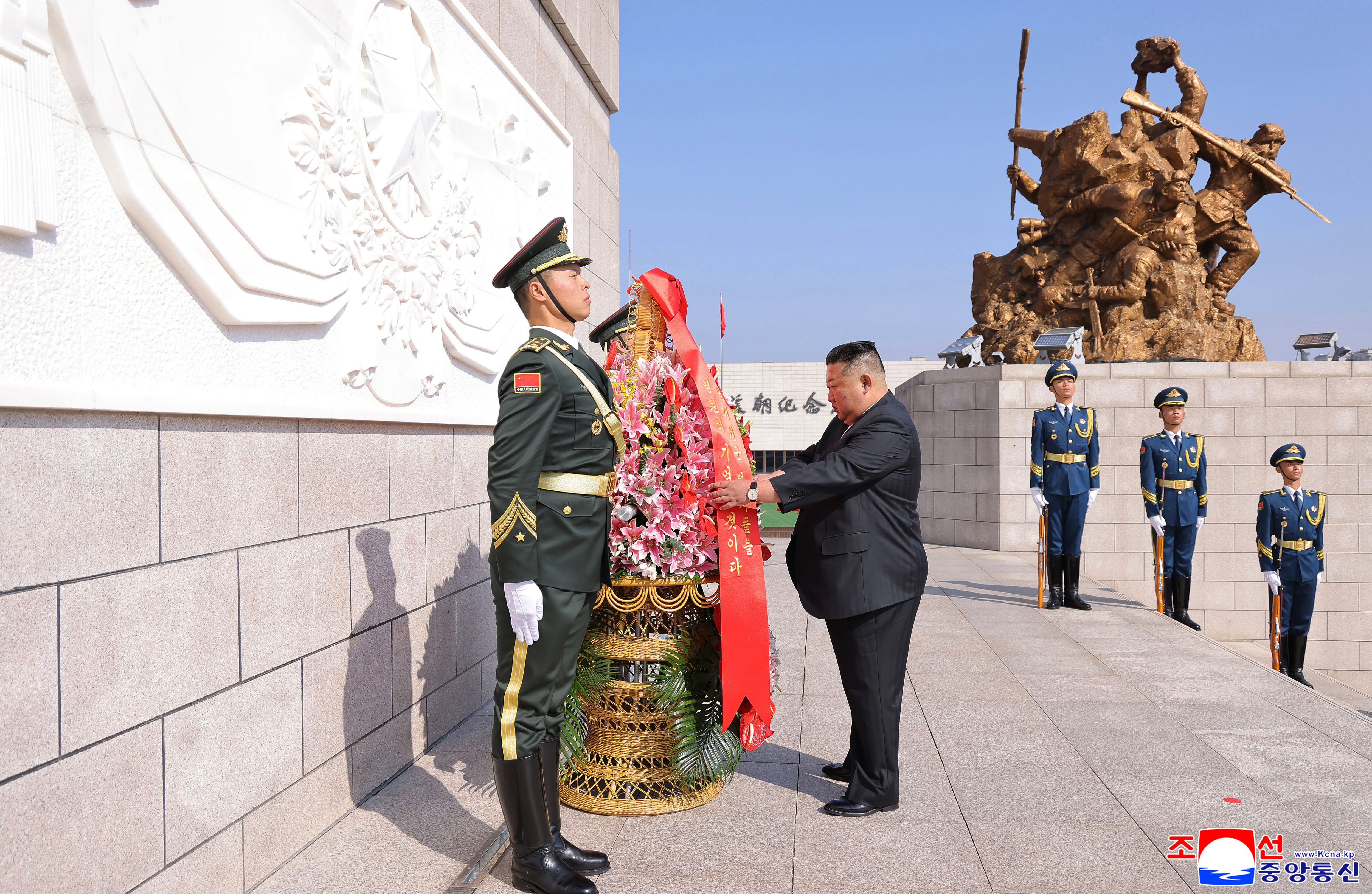 In this photo provided by the North Korean government, its leader Kim Jong Un offers a wreath at a monument in Dandong, China