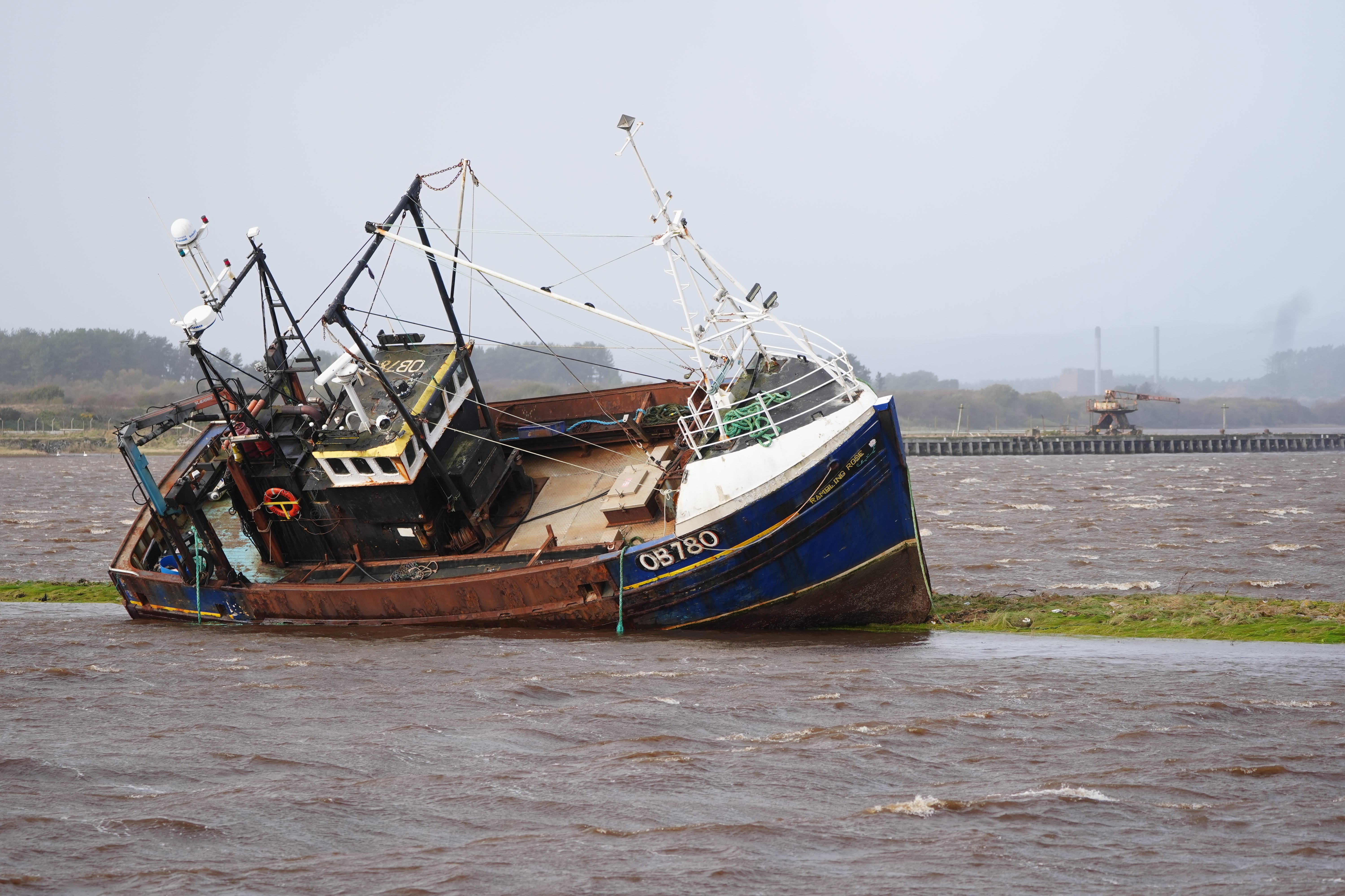 A fishing boat is stranded at Irvine Harbour in Ayrshire after coming loose from its moorings