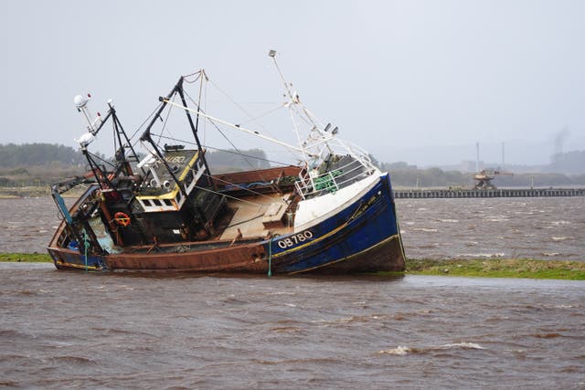 A fishing boat is stranded at Irvine Harbour in Ayrshire after coming loose from its moorings
