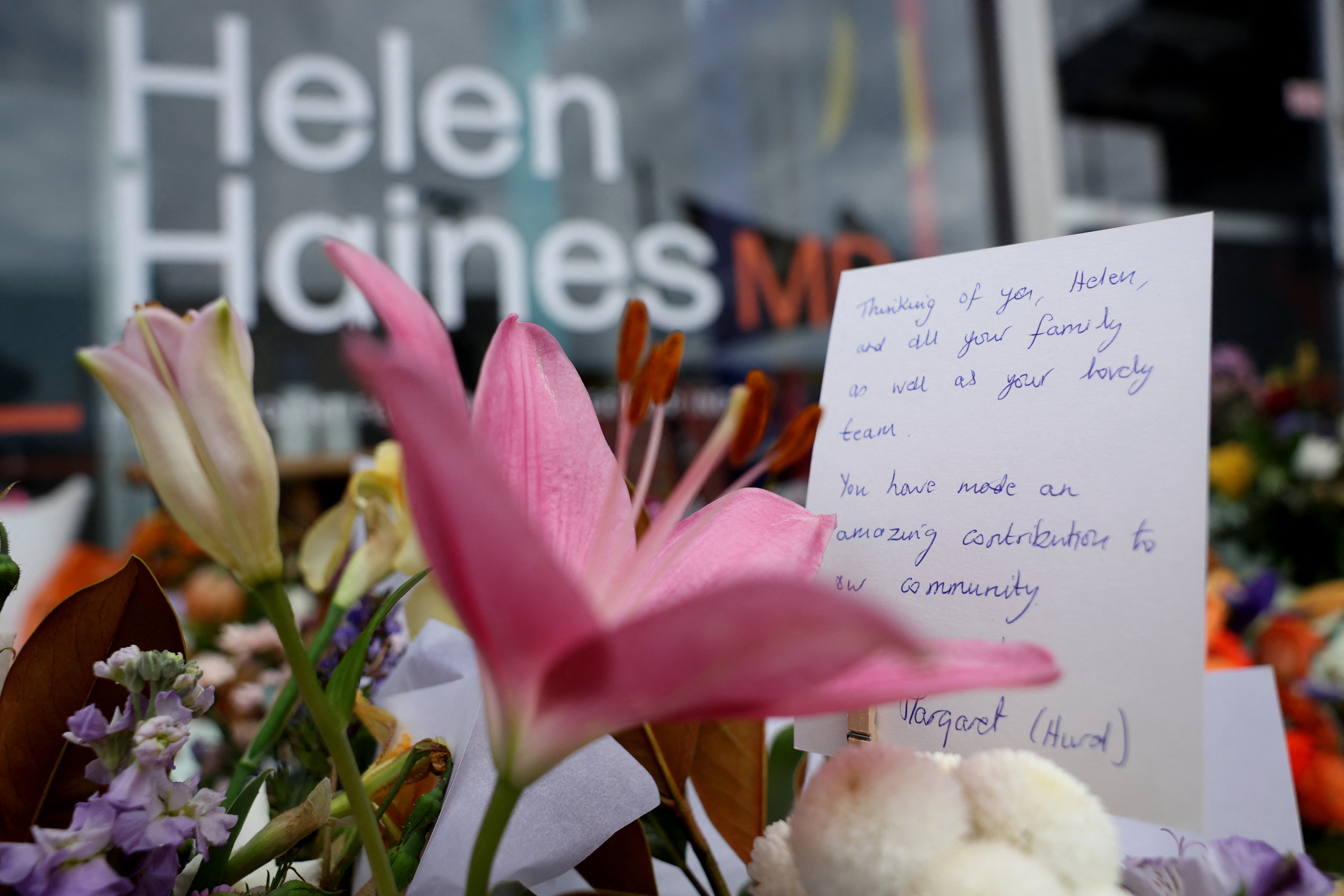 Floral tributes are placed outside the offices of Australian lawmaker Helen Haines who was critically wounded in a 