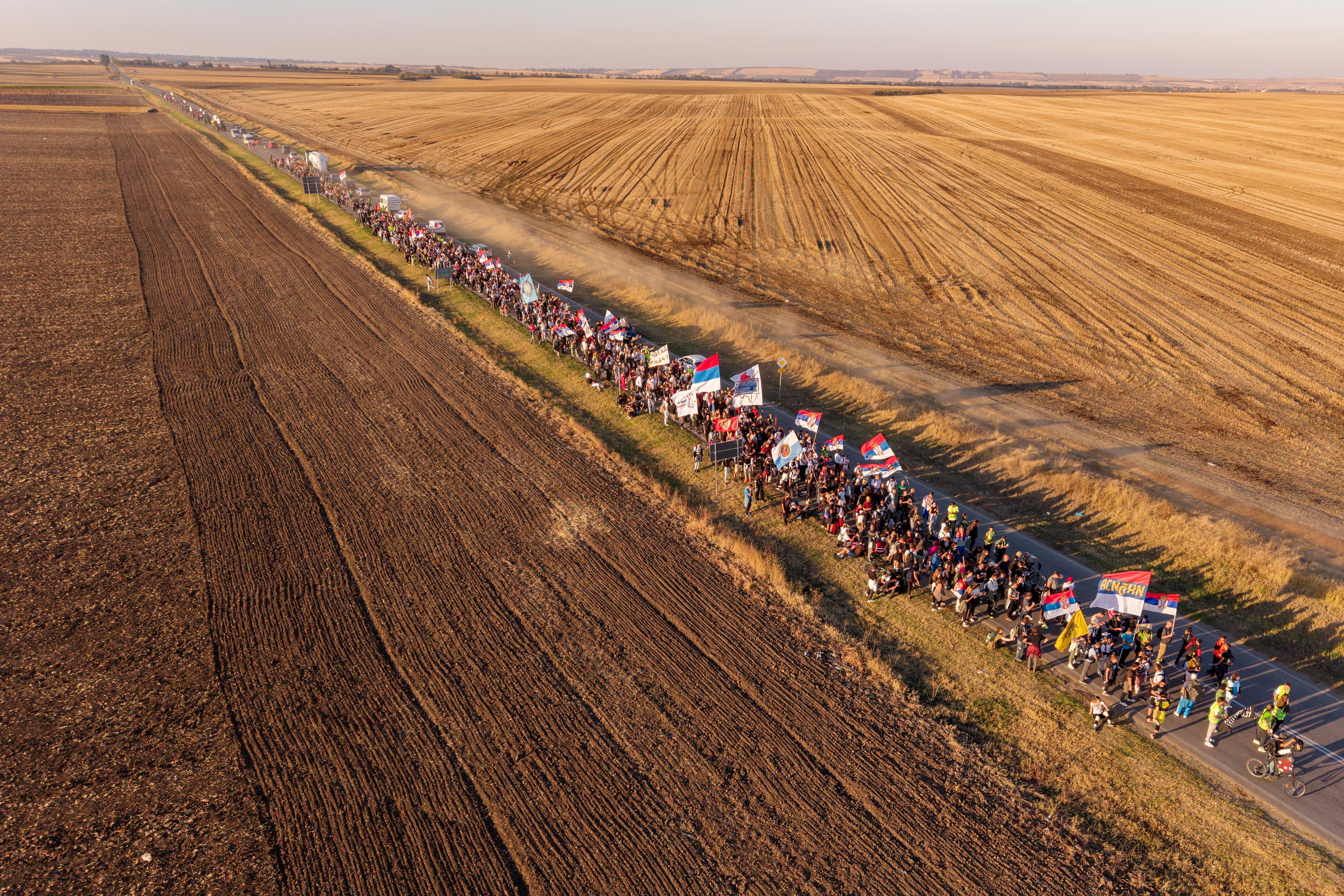 A drone view shows students from Novi Sad walking along a road through the fields on their way to Belgrade near the town of Indjija, Serbia.